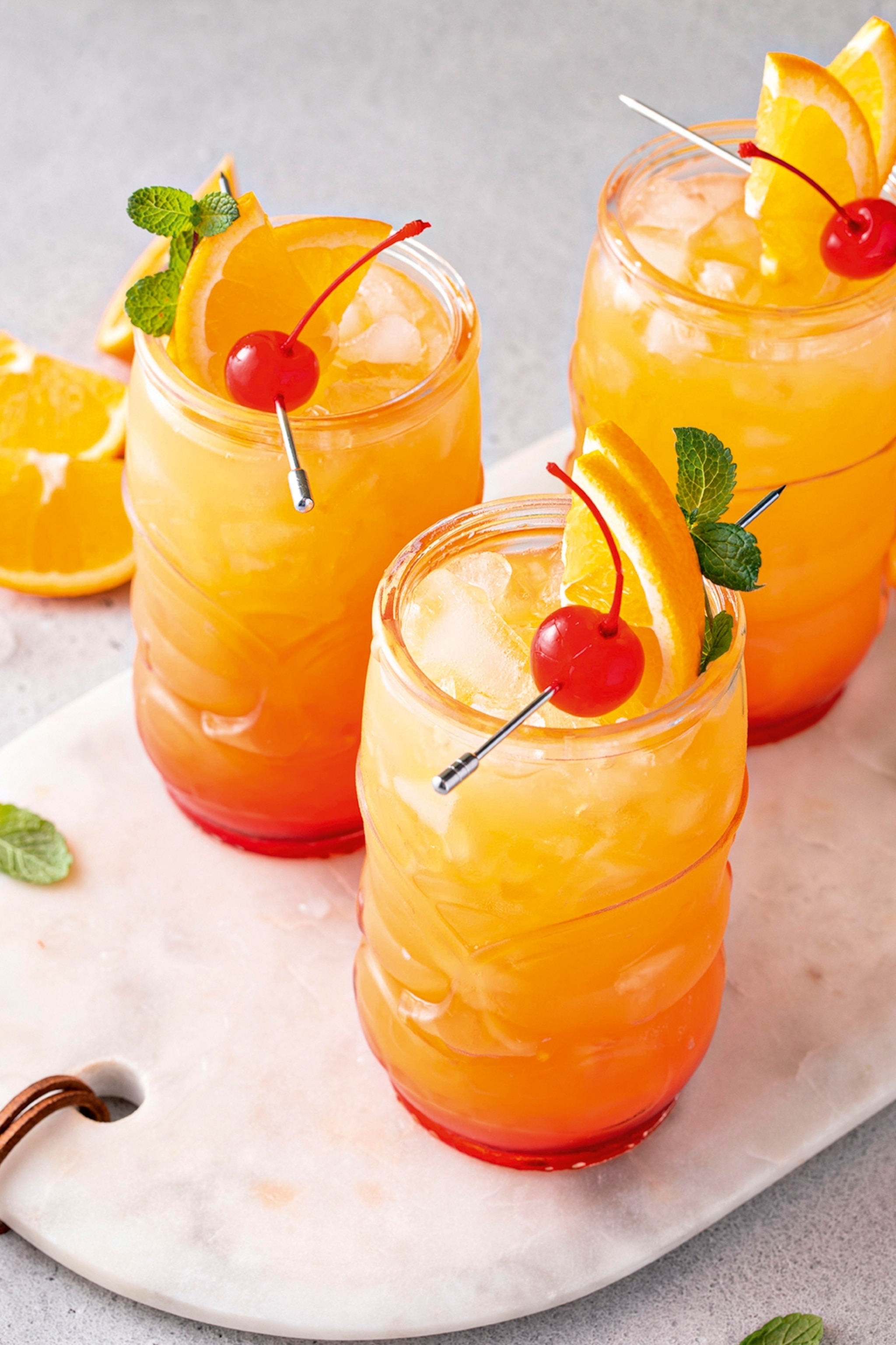 three glasses of orange rum punch