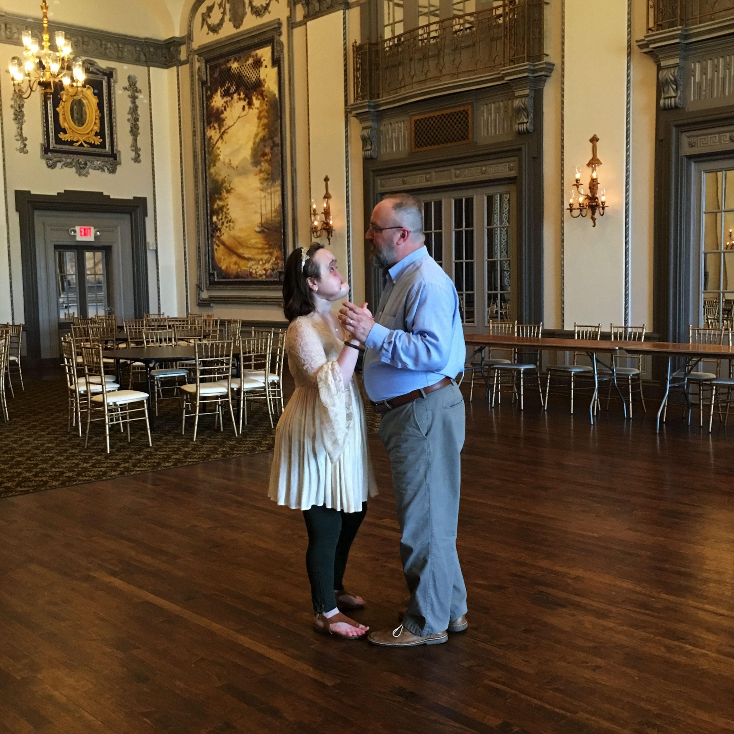 a woman and her father dancing
