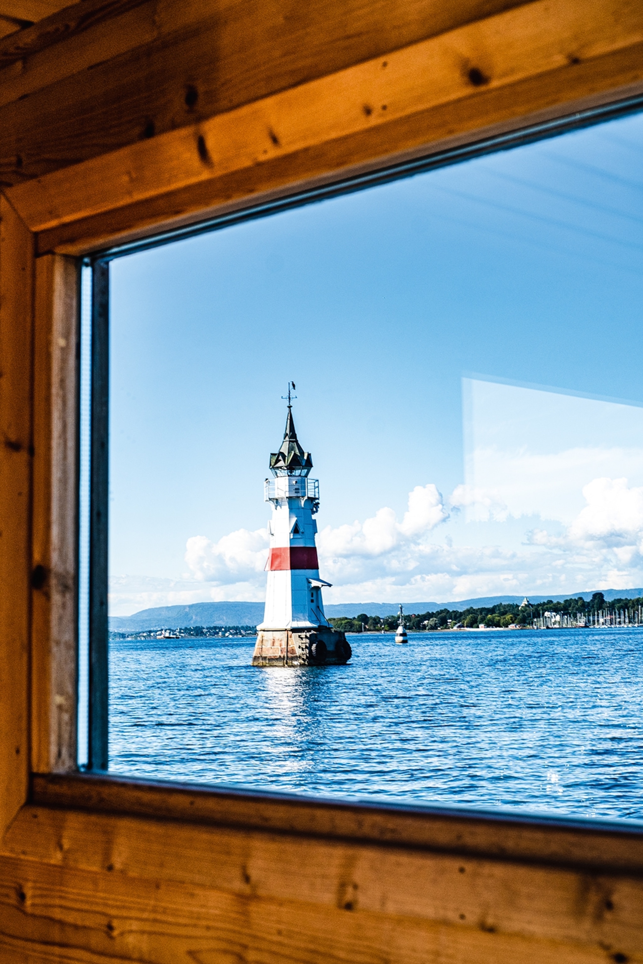 Views of a lighthouse in the Oslofjord during a sauna cruise.