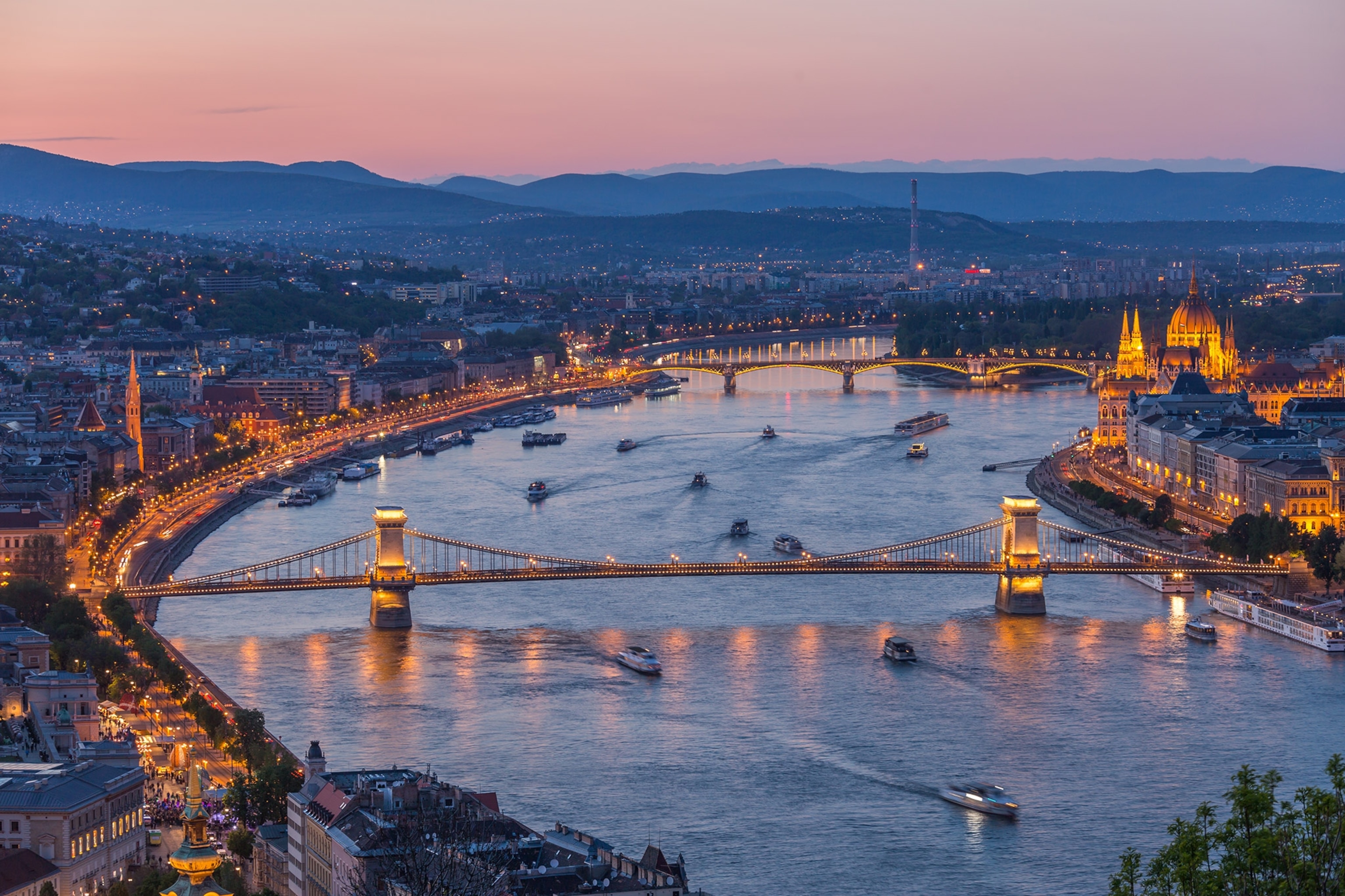 High angle view of Budapest at twilight over ships in the Danube River