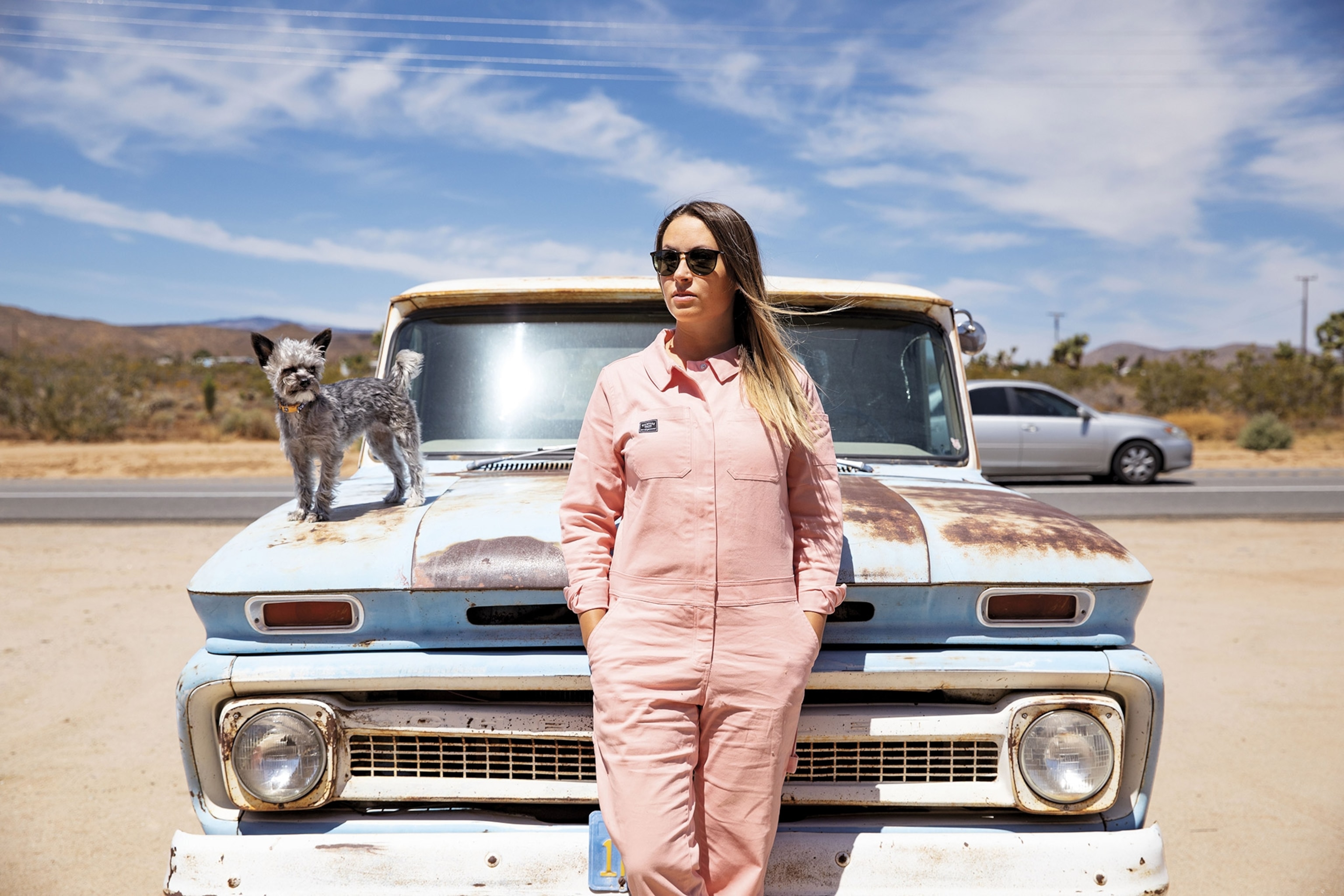 a woman with her dog and a truck in Landers, California