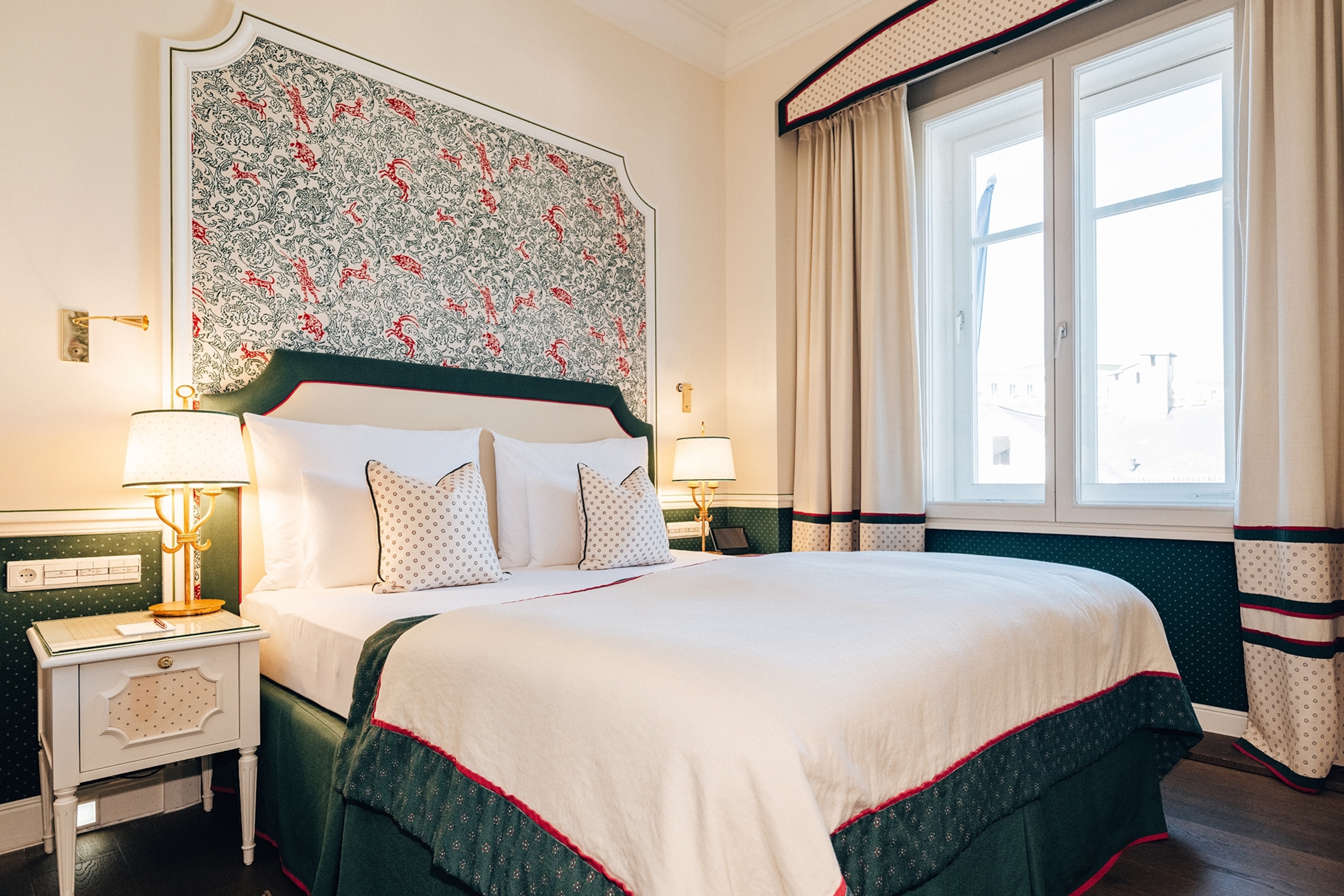 A modern and subtly hunting-themed bedroom with velvet skirting around the bed.