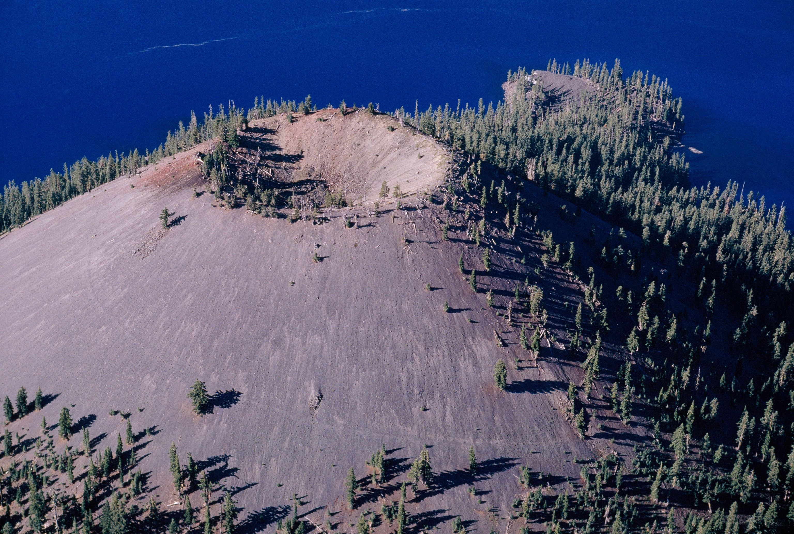 A volcano inside a volcano, Wizard Island rises above Crater Lake in this archival photo from July, 1962