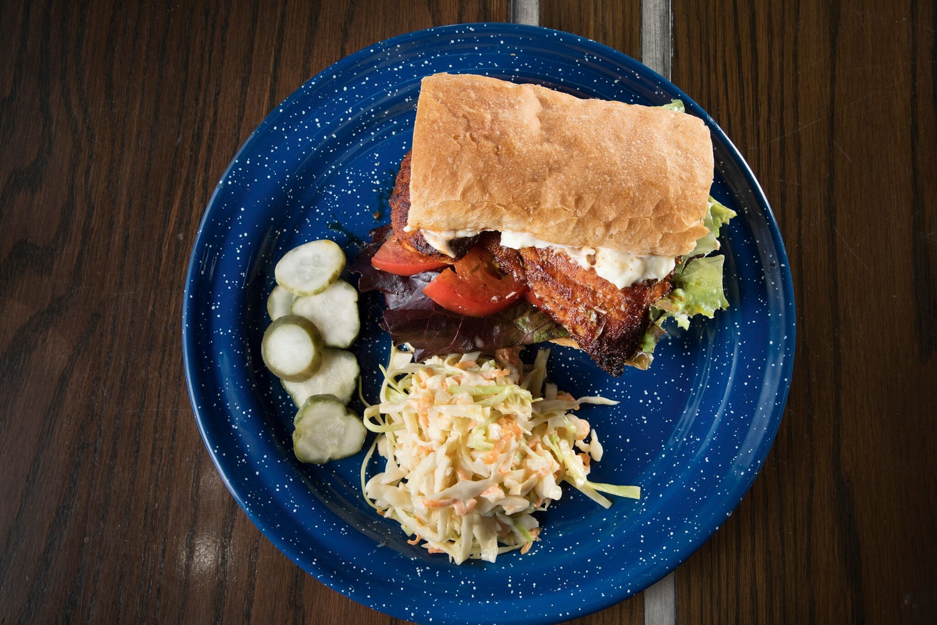 Fried chicken sandwich with coleslaw and pickles at The Grey.