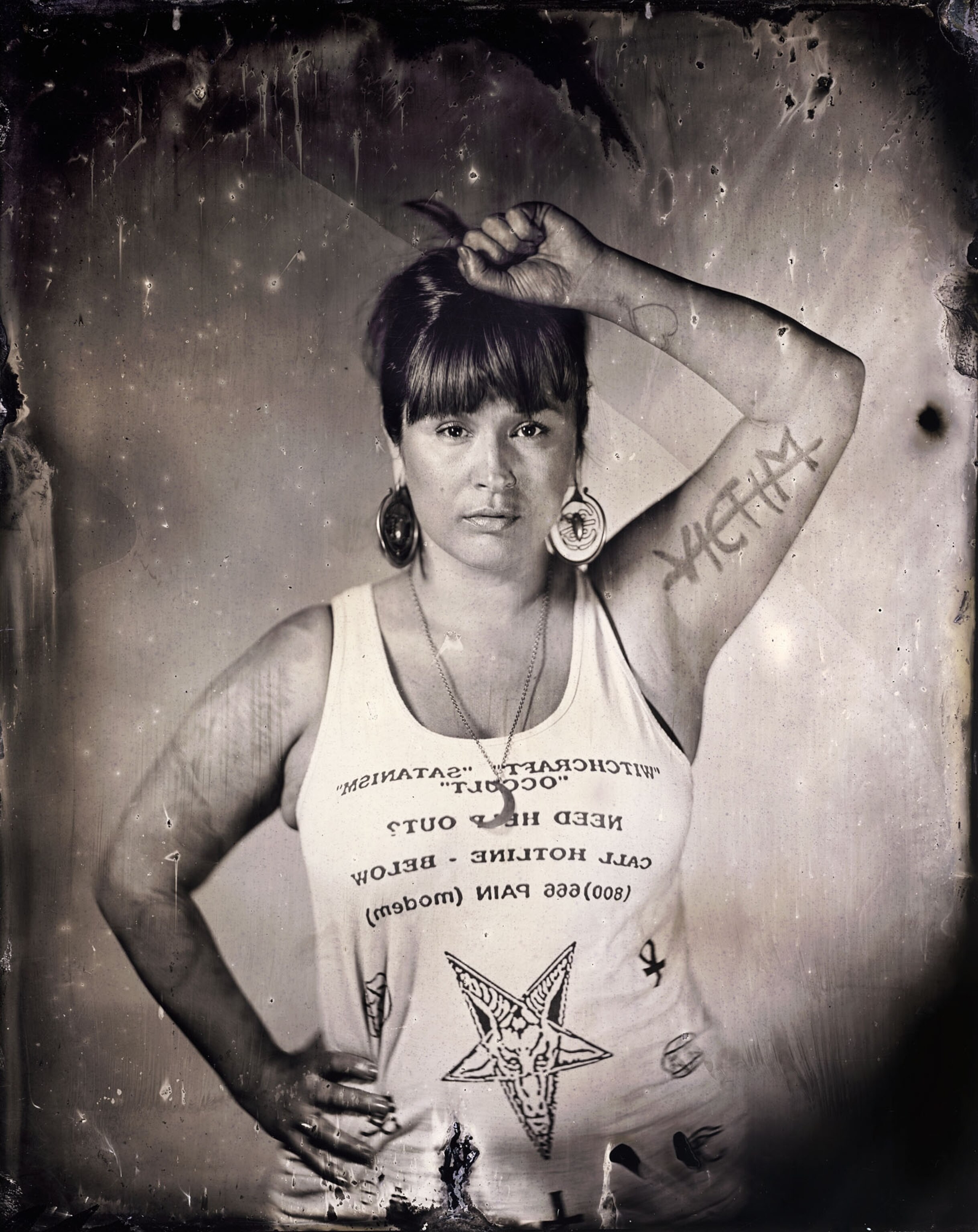 a tintype of a woman raising her hand