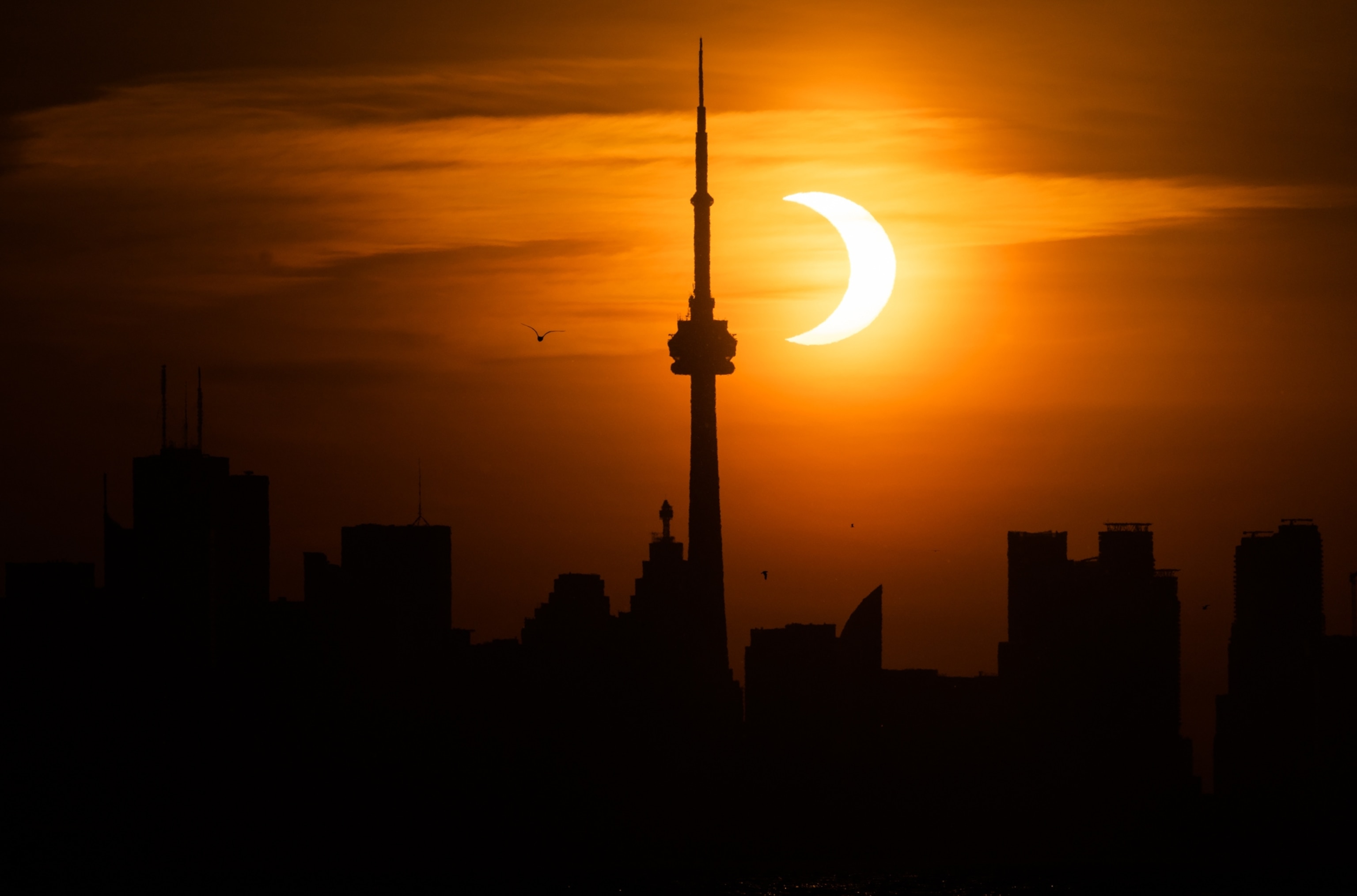 The sun rises behind the skyline during an annular eclipse on June 10, 2021.
