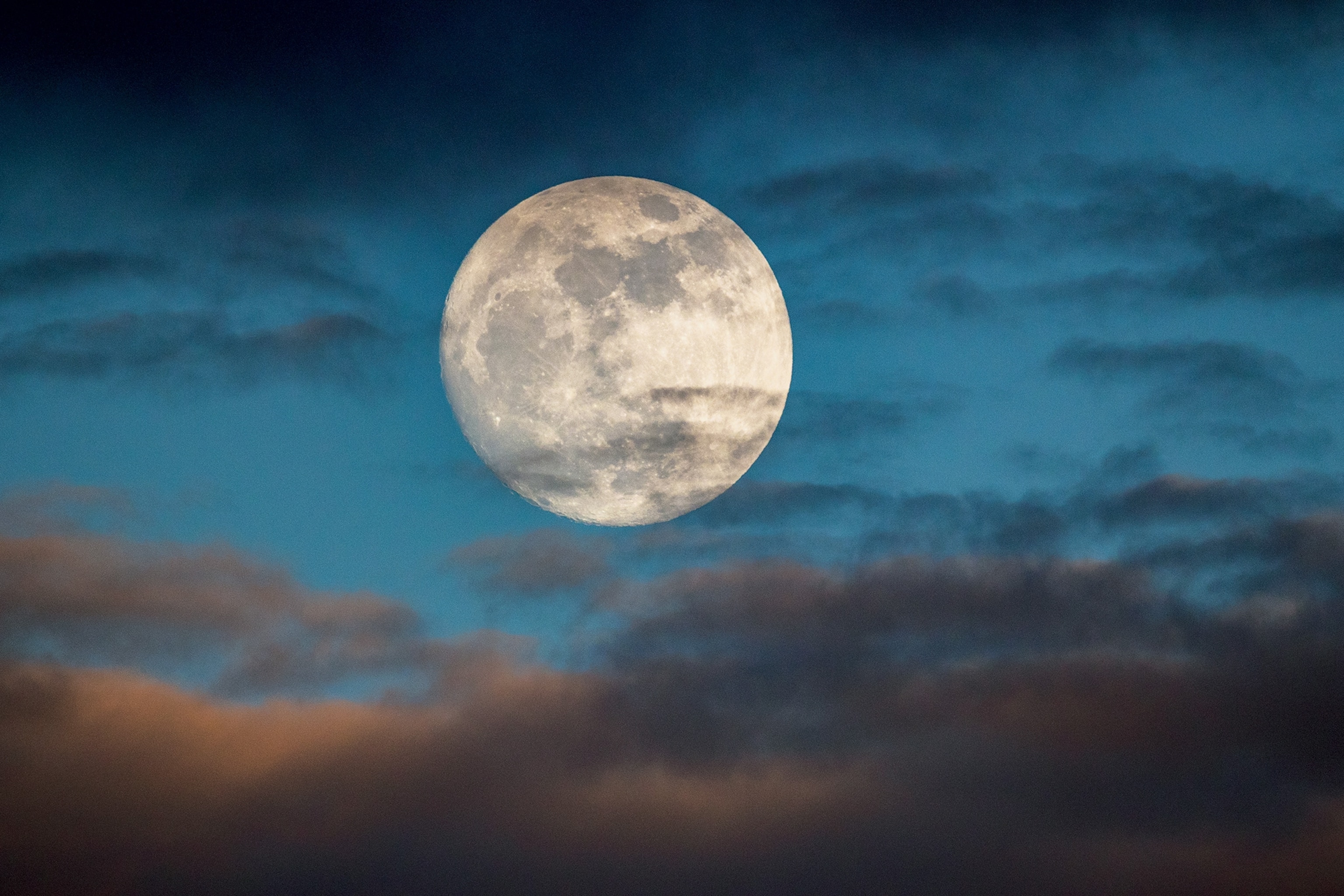 A full moon on a cloudy night