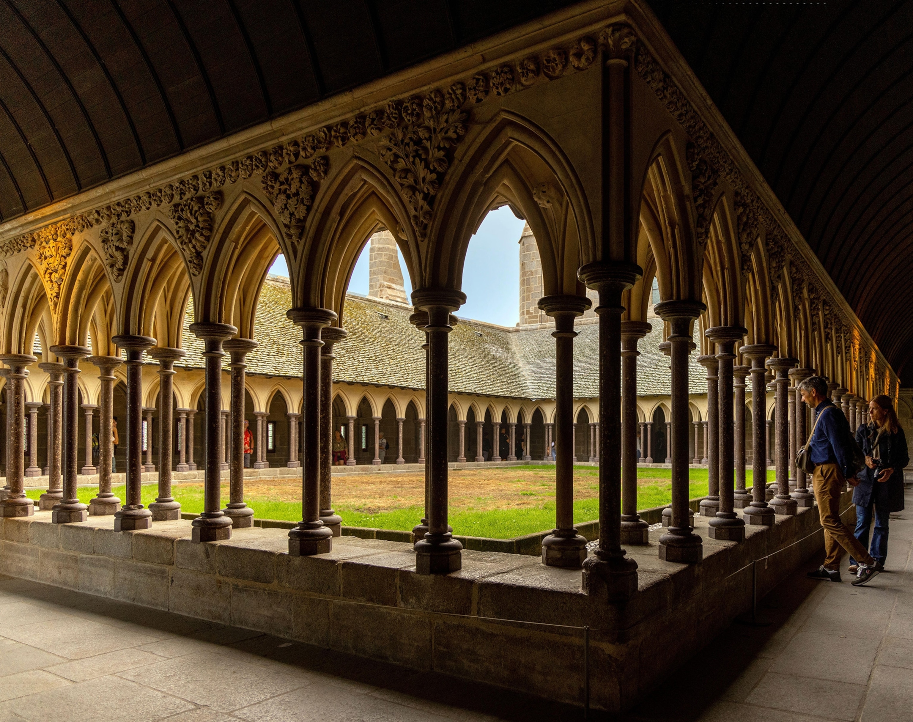 People viewing surrounding area in Le Mont Saint-Michel cloisters.