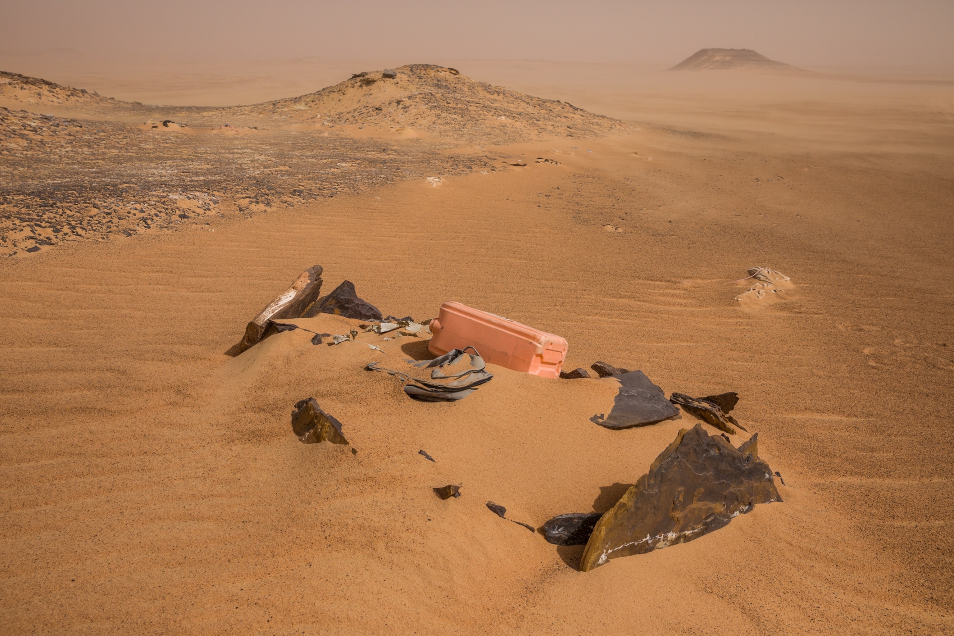 a makeshift tomb engulfed with sand in the desert