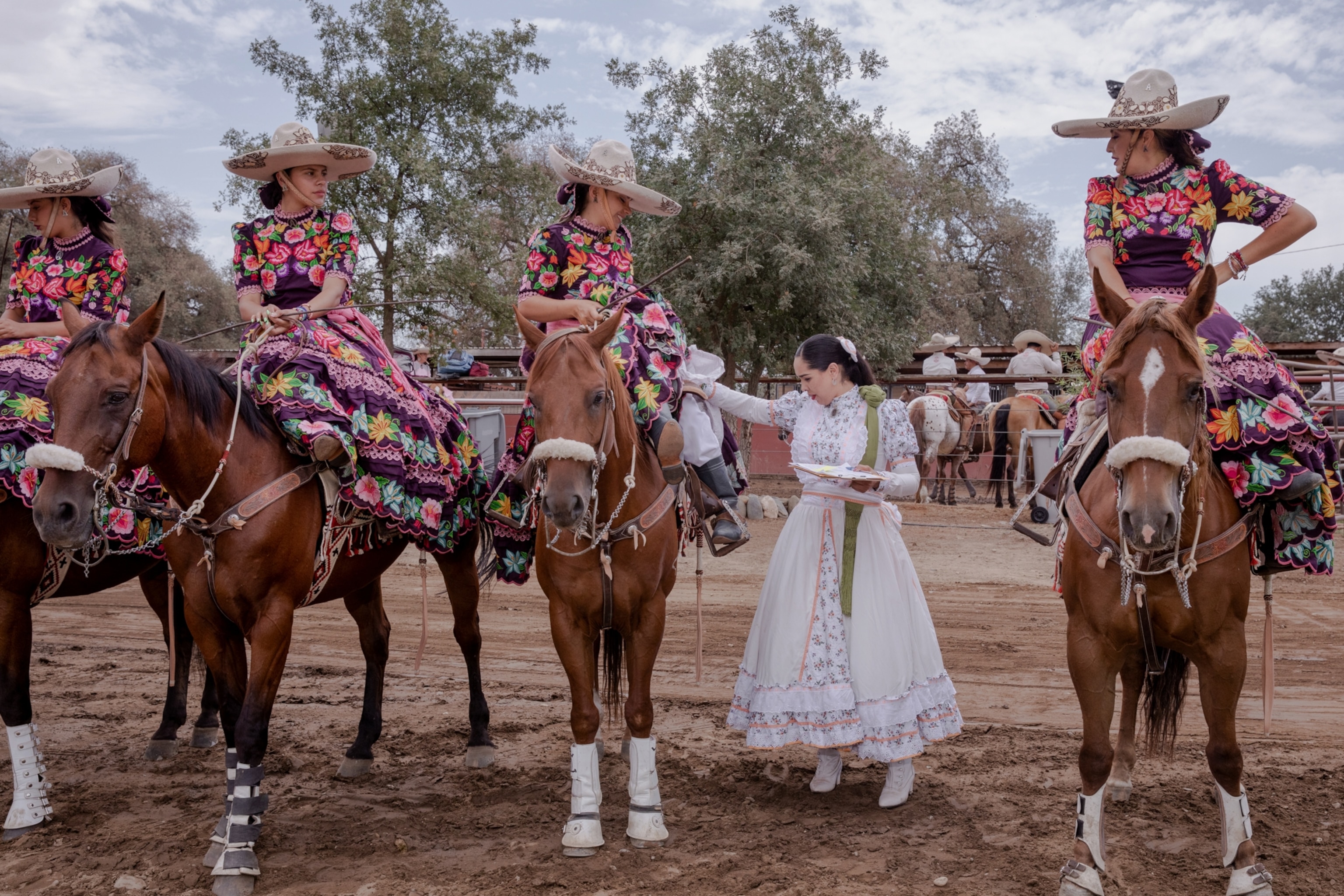 judges examine outfits of competitors at a rodeo