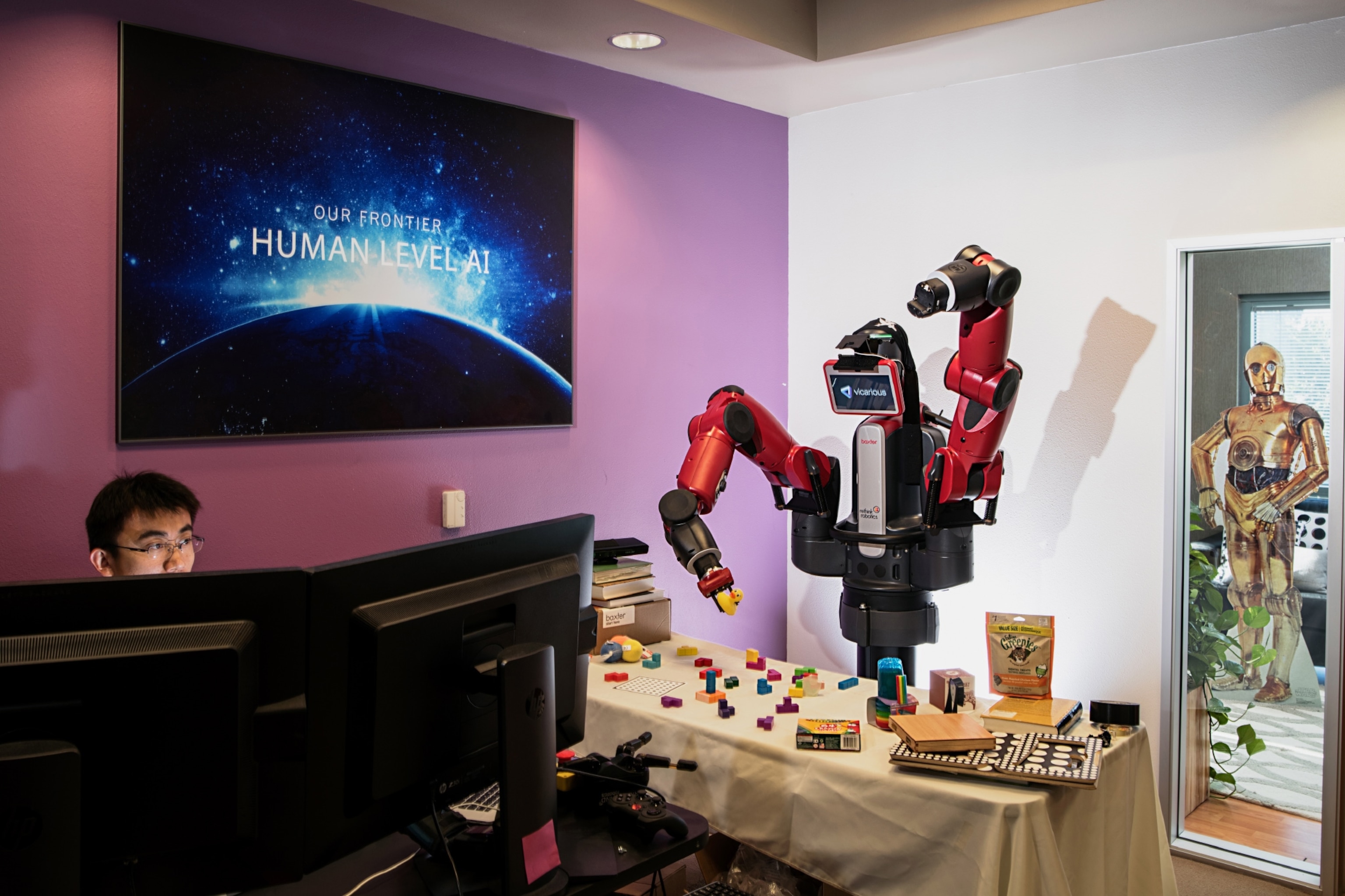 scientist teaching a robot how to recognize and manipulate objects.