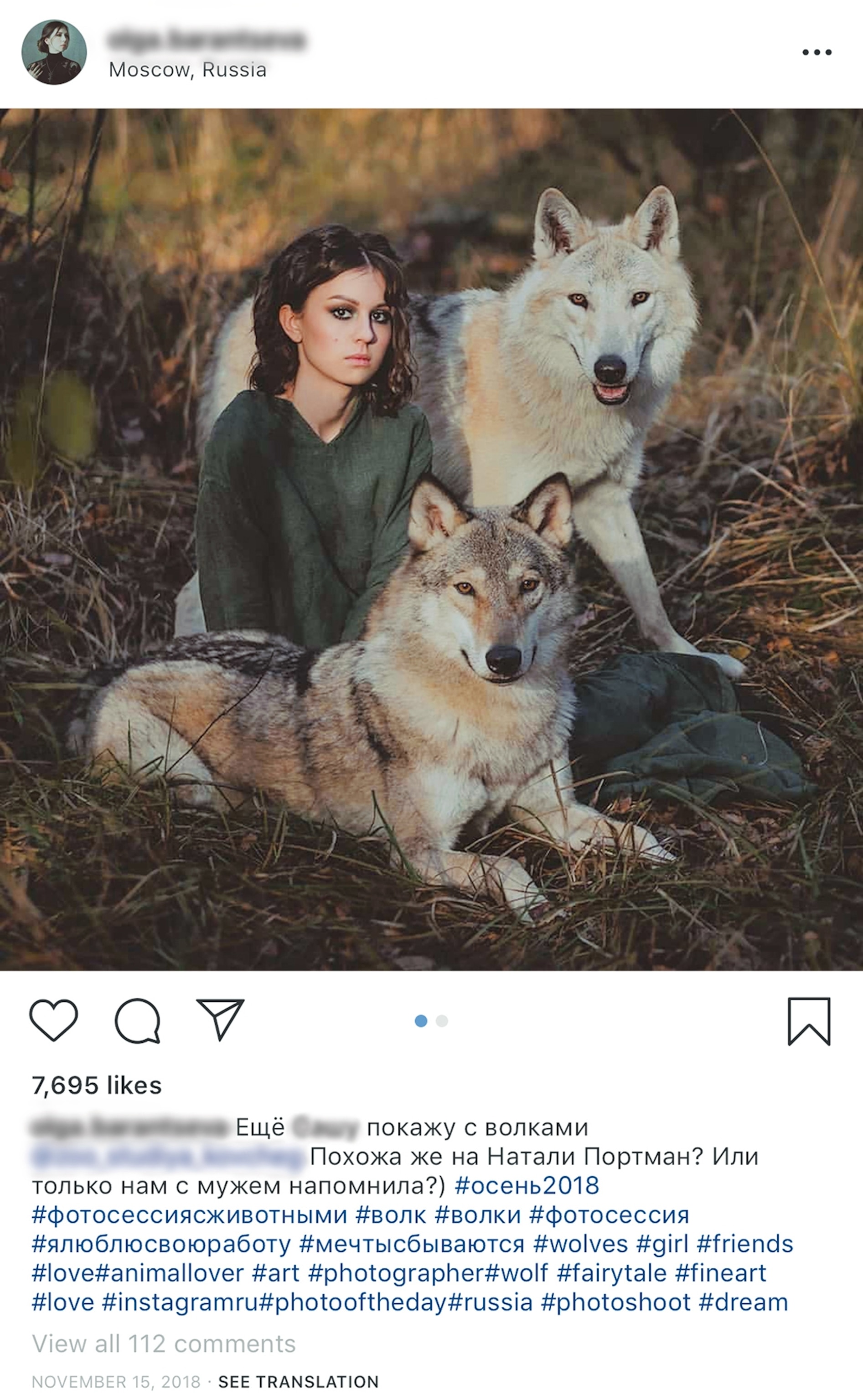 a girl posing for a photograph with wolves