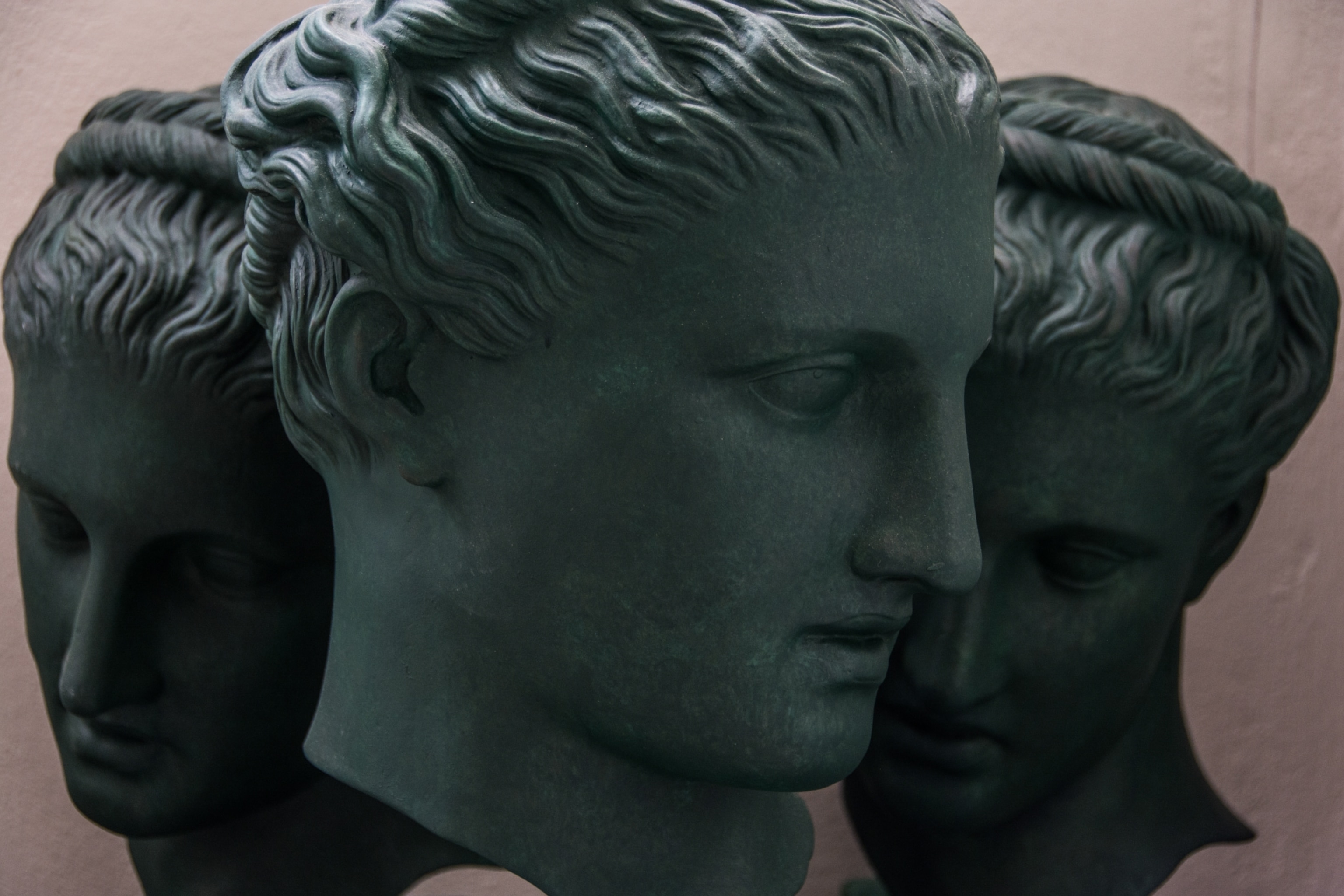 Three heads of the same statue sit side bye side awaiting the next phase of production