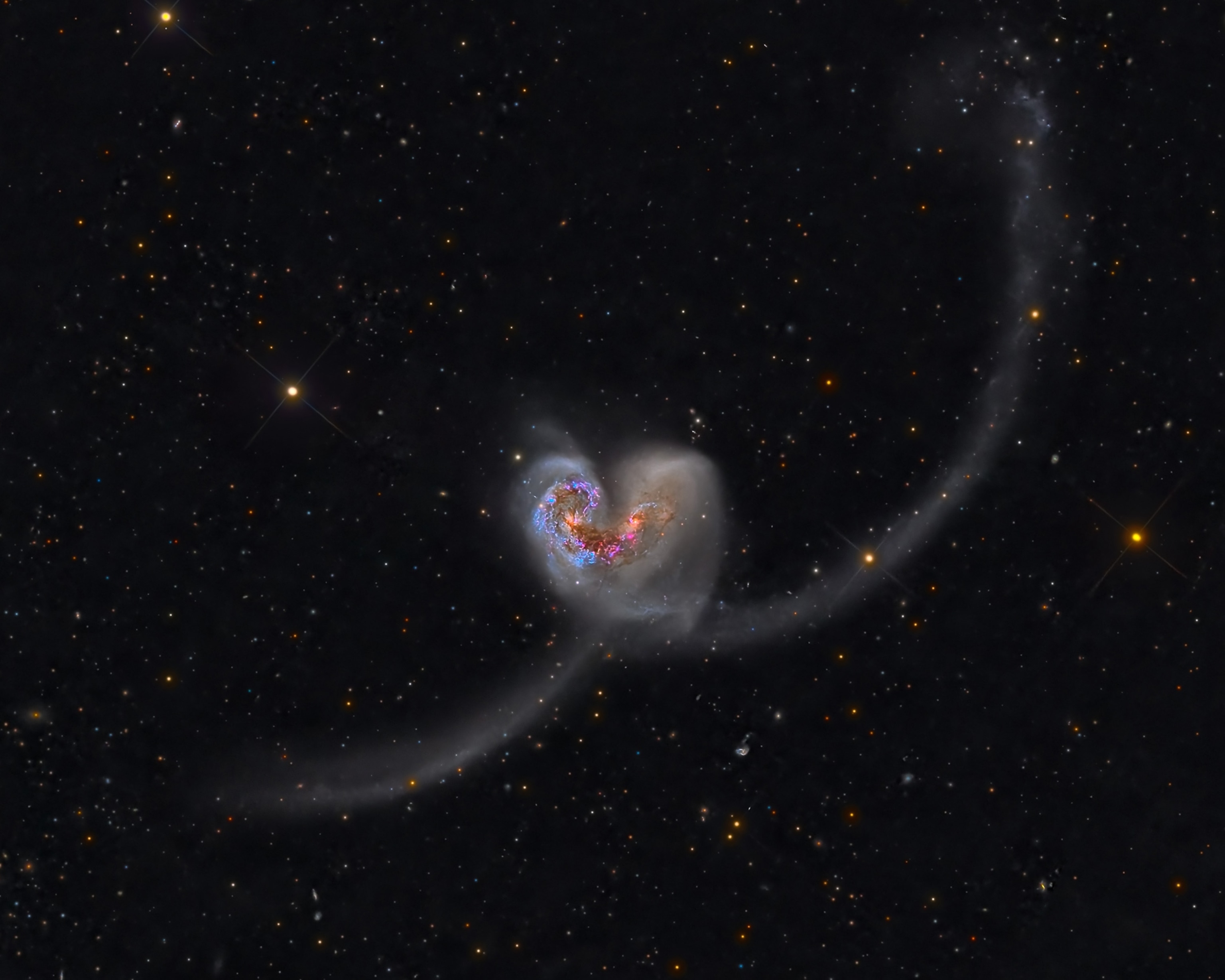 The pair of galaxies cataloged as NGC 4038 and NGC 4039, known as the Antennae Galaxies, make a heart shape in space.
