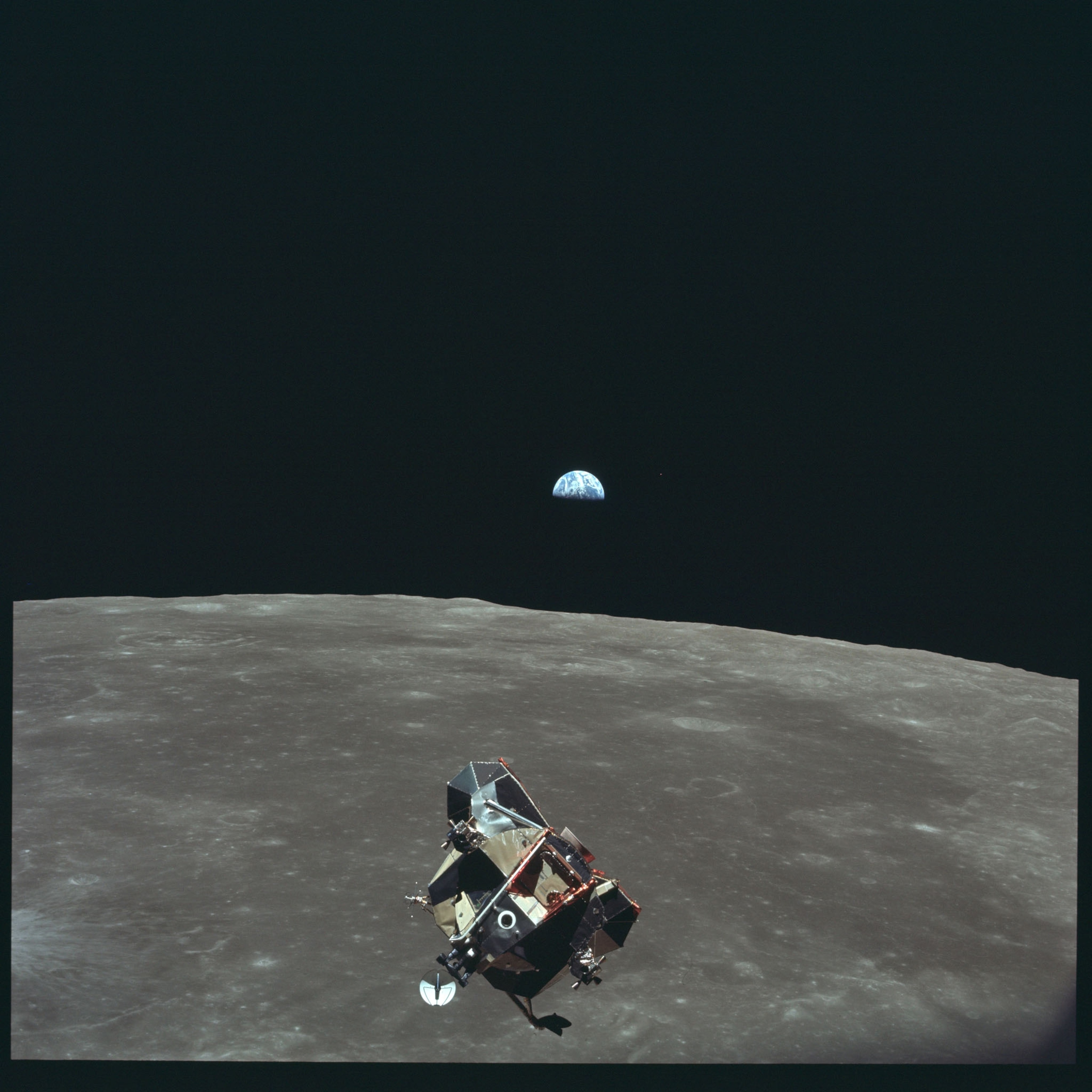the lunar lander above the moon with earth behind