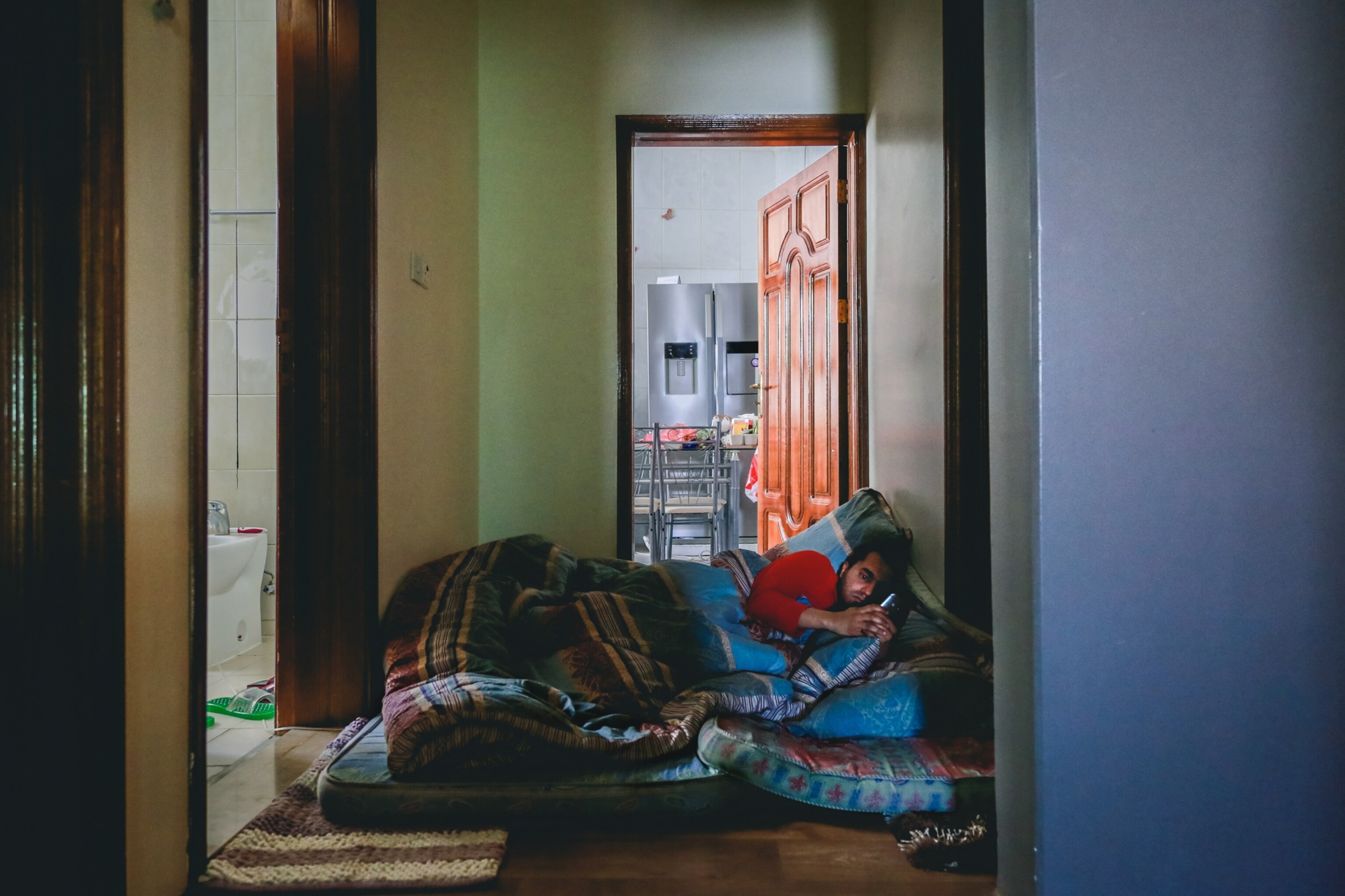 a person sleeping on a cot in a hallway