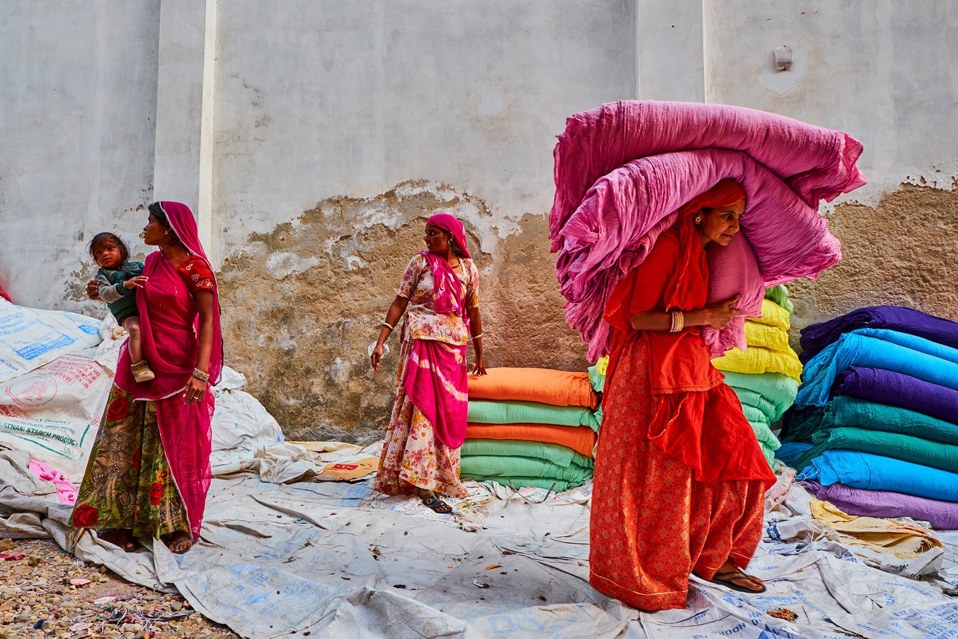 women collecting textiles for sari production