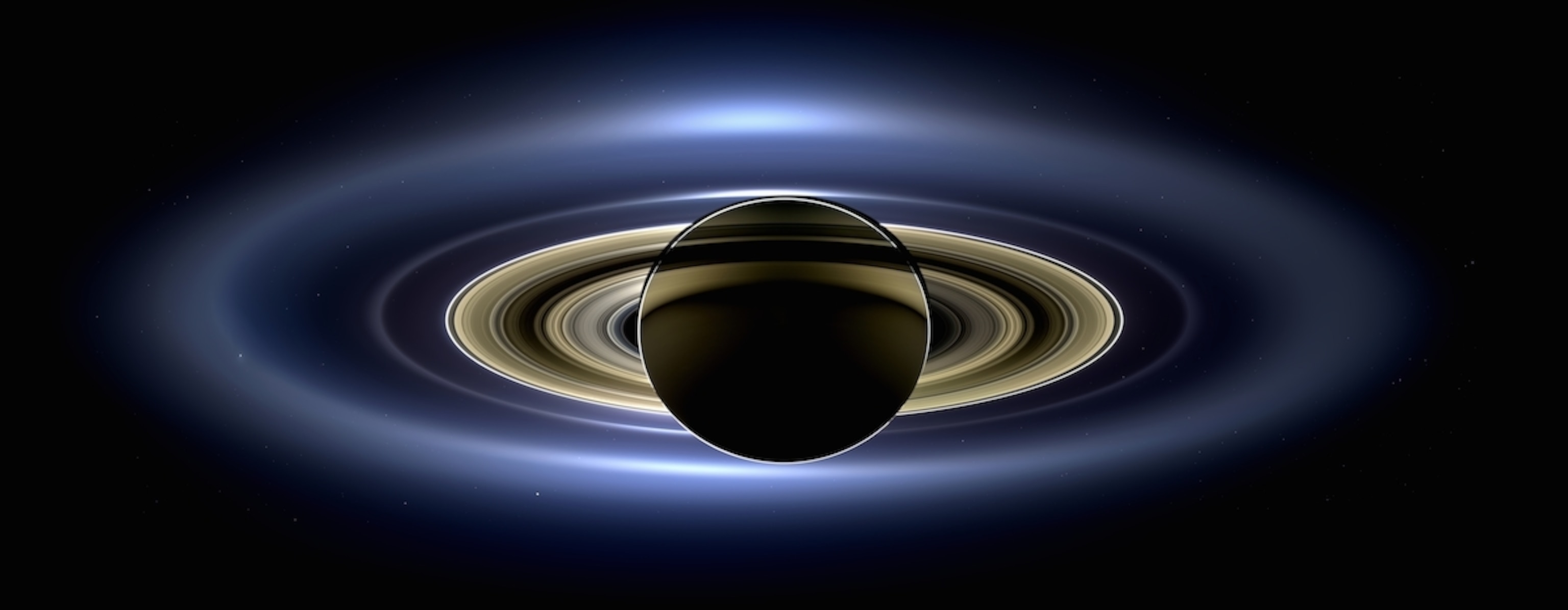Saturn in silhouette, glimpsed by Cassini last year. Earth is a speck near the planet's lower right. (NASA/JPL/Space Science Institute)