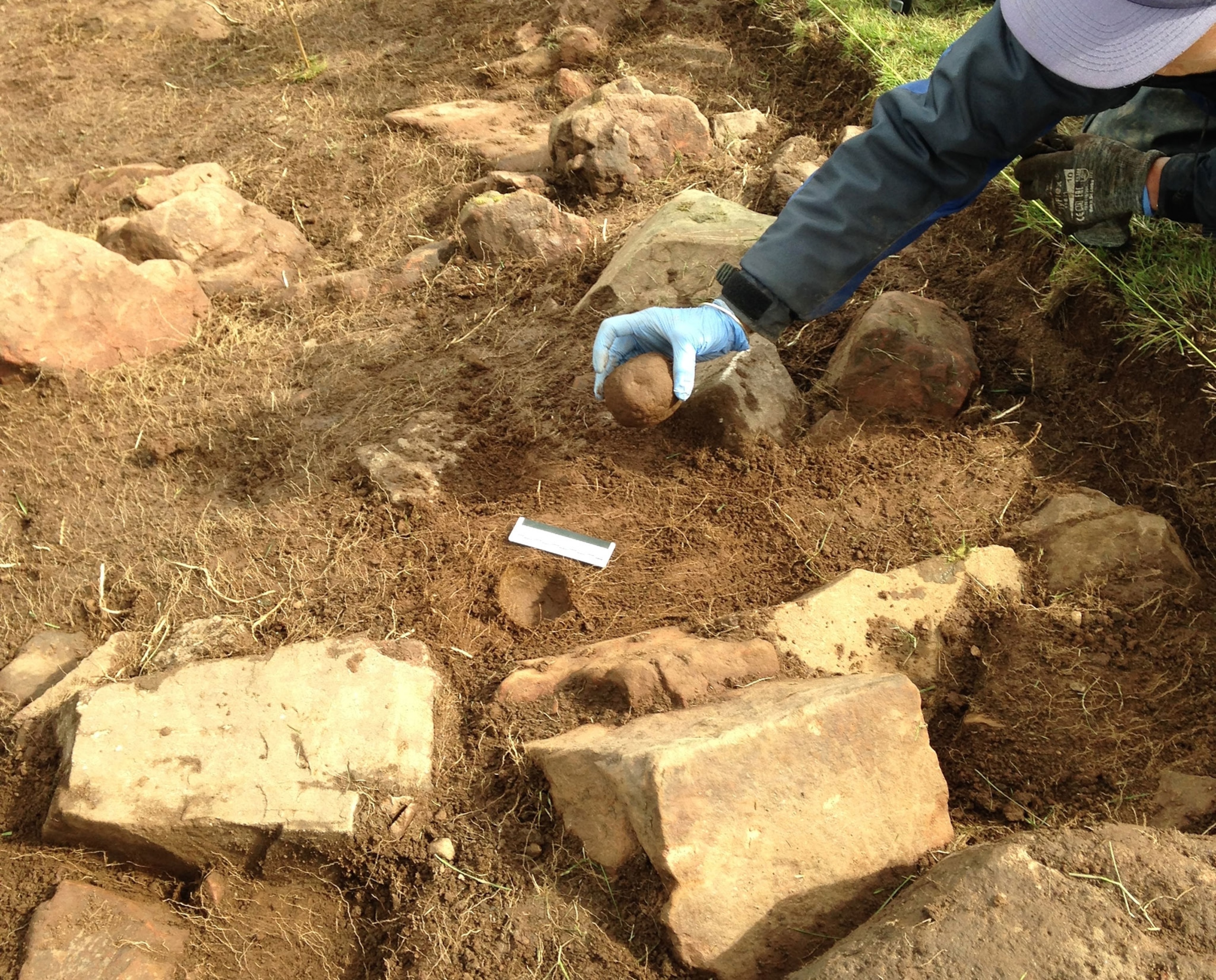 a carved stone ballista excavated from a fallen hillfort rampart in Scotland