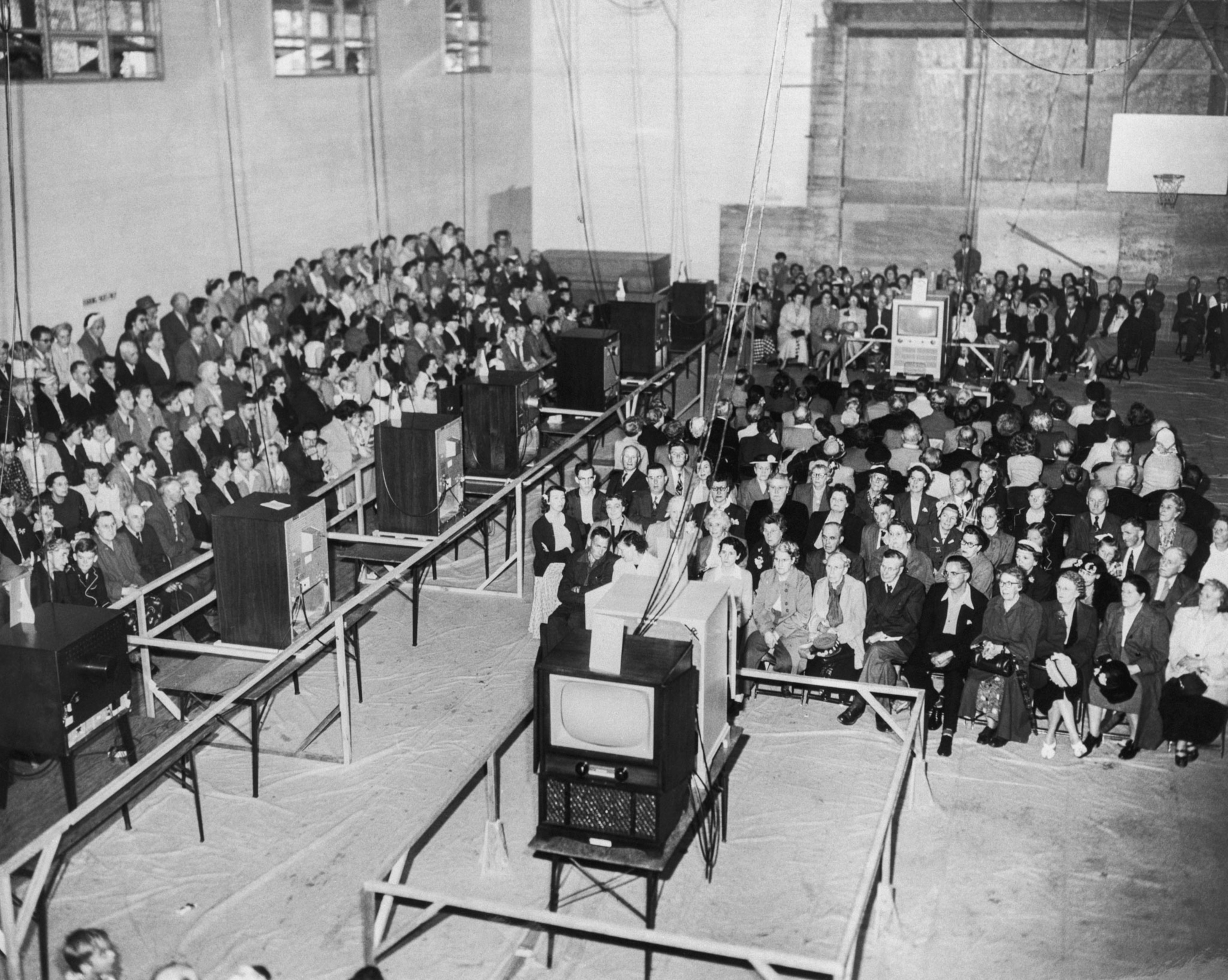 A black and white photo of people in Canada watching the first televised coronation of Queen Elizabeth II