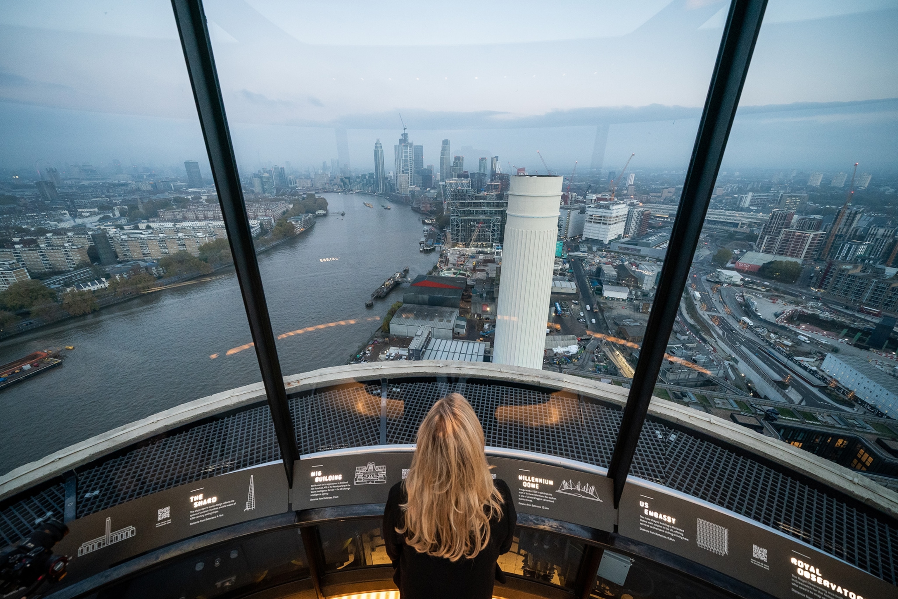 A person looks out over London from Observation deck Lift 109 of the renovated Battersea Power Station.