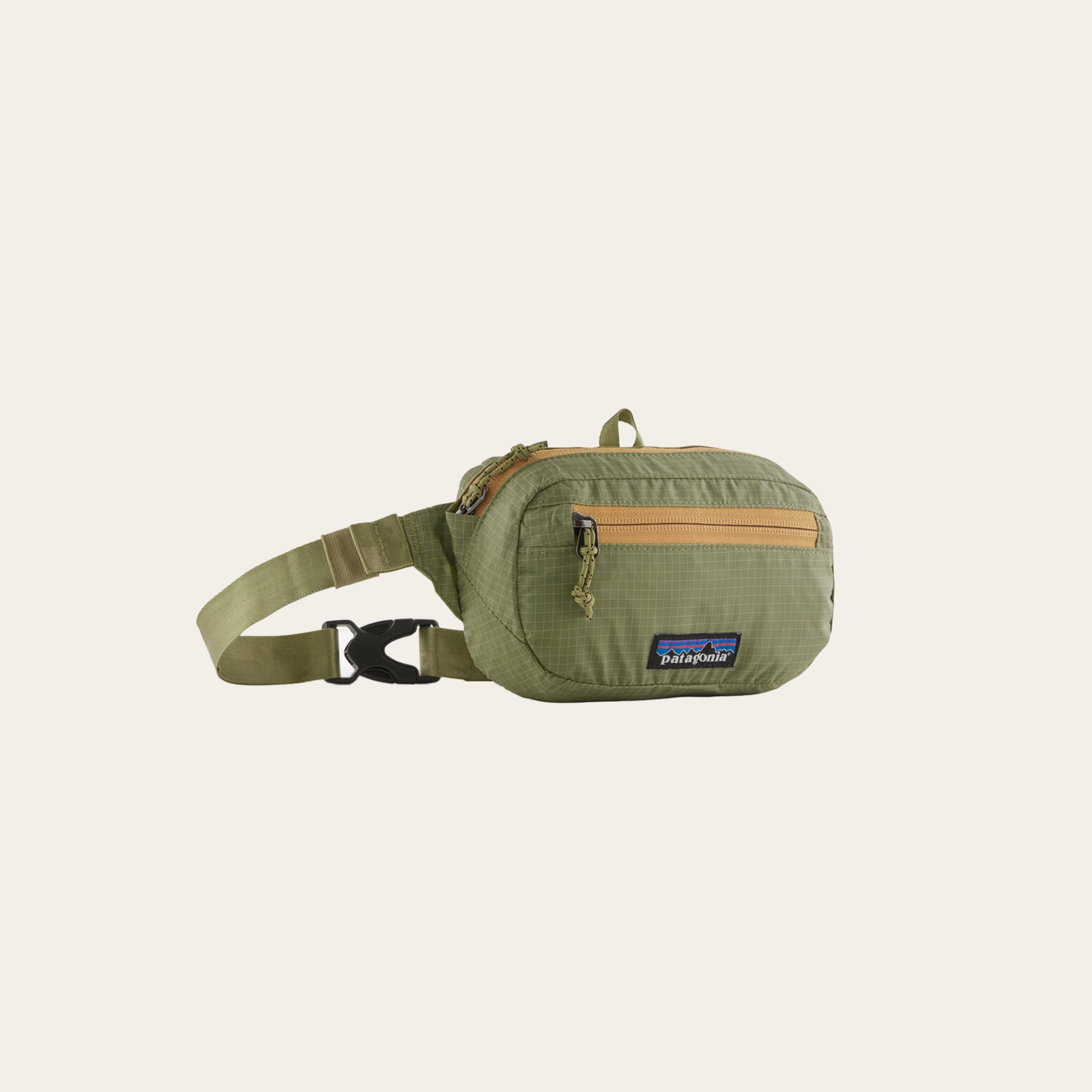 A soft green bag and olive zipper on a cream background.
