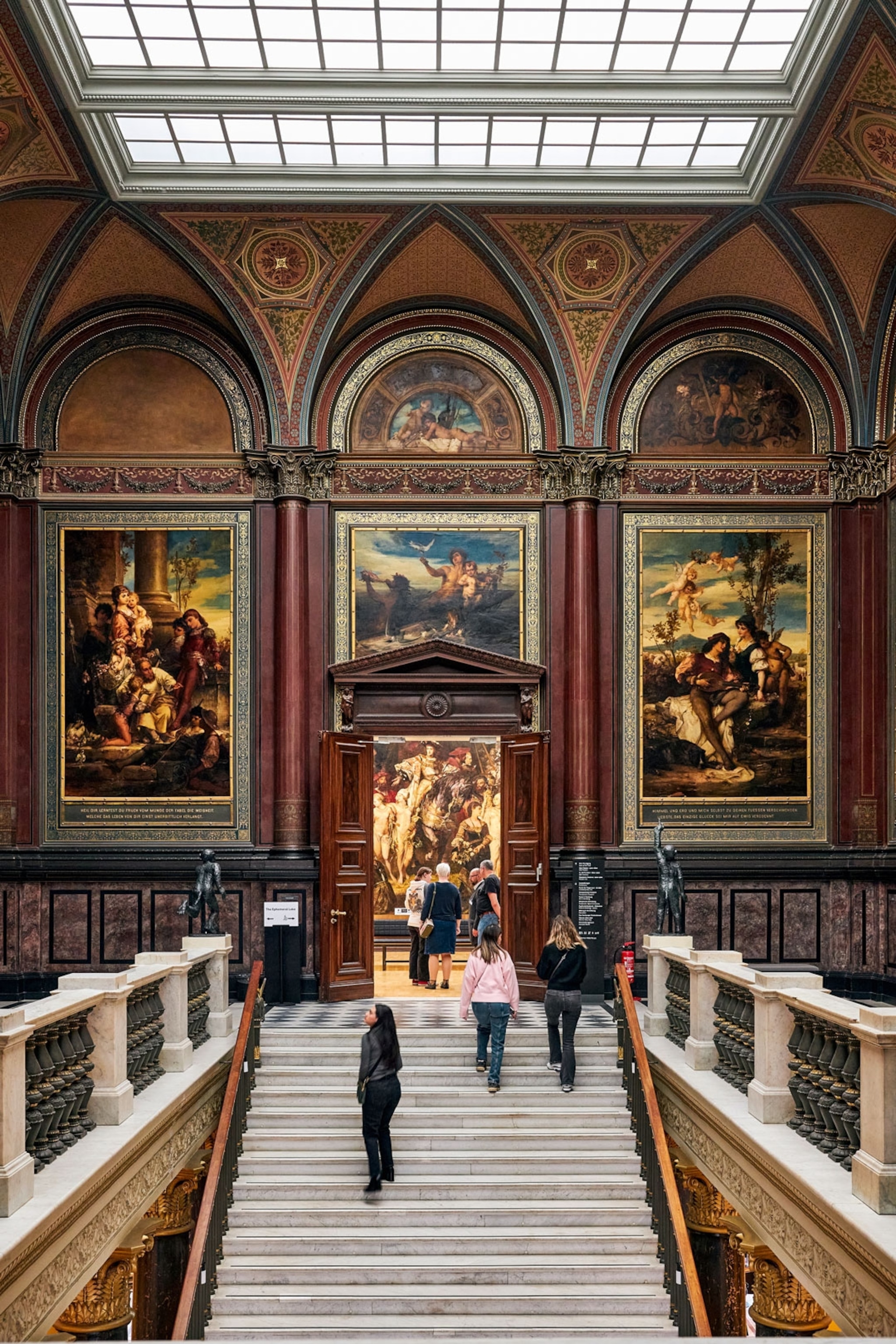 Paintings on display in the interior of an art gallery.