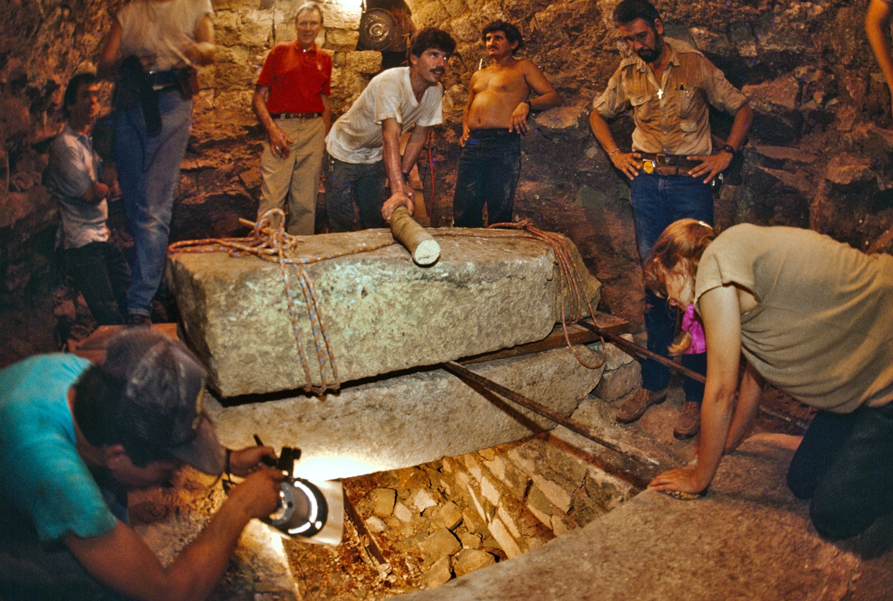 Picture of people around stone sarcophagus.
