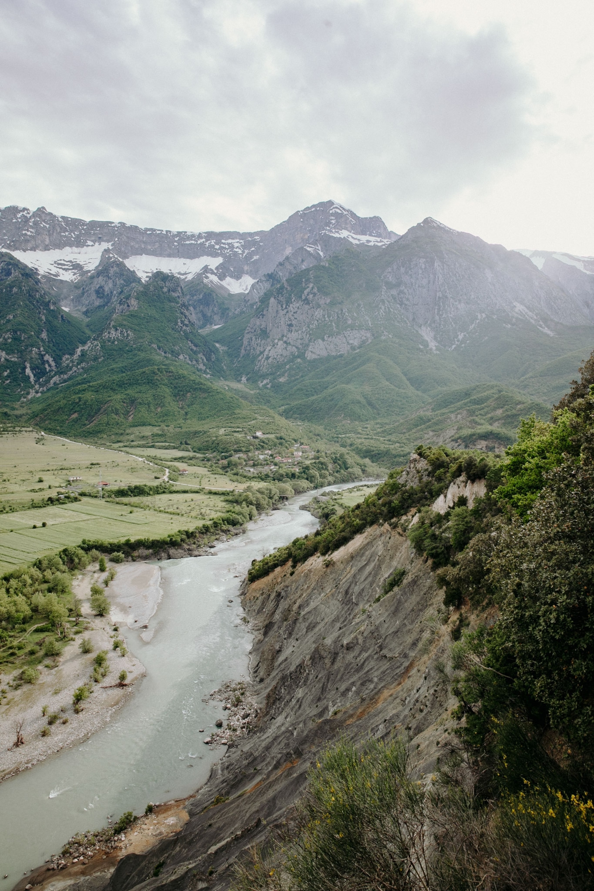 a view of a river surrounded by tall mountains in Albania