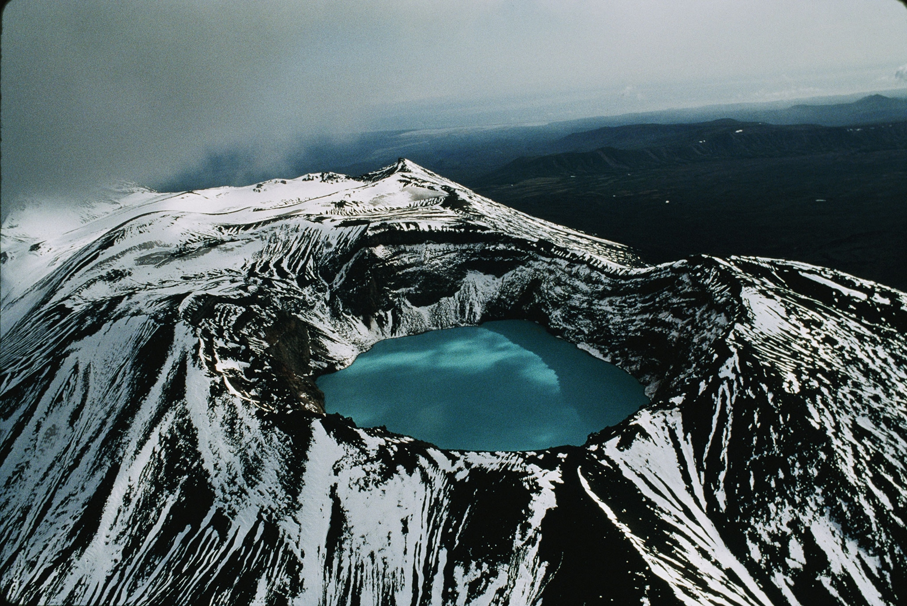 an aerial view of a crater lake in one of Kamchatka's many volcanoes.