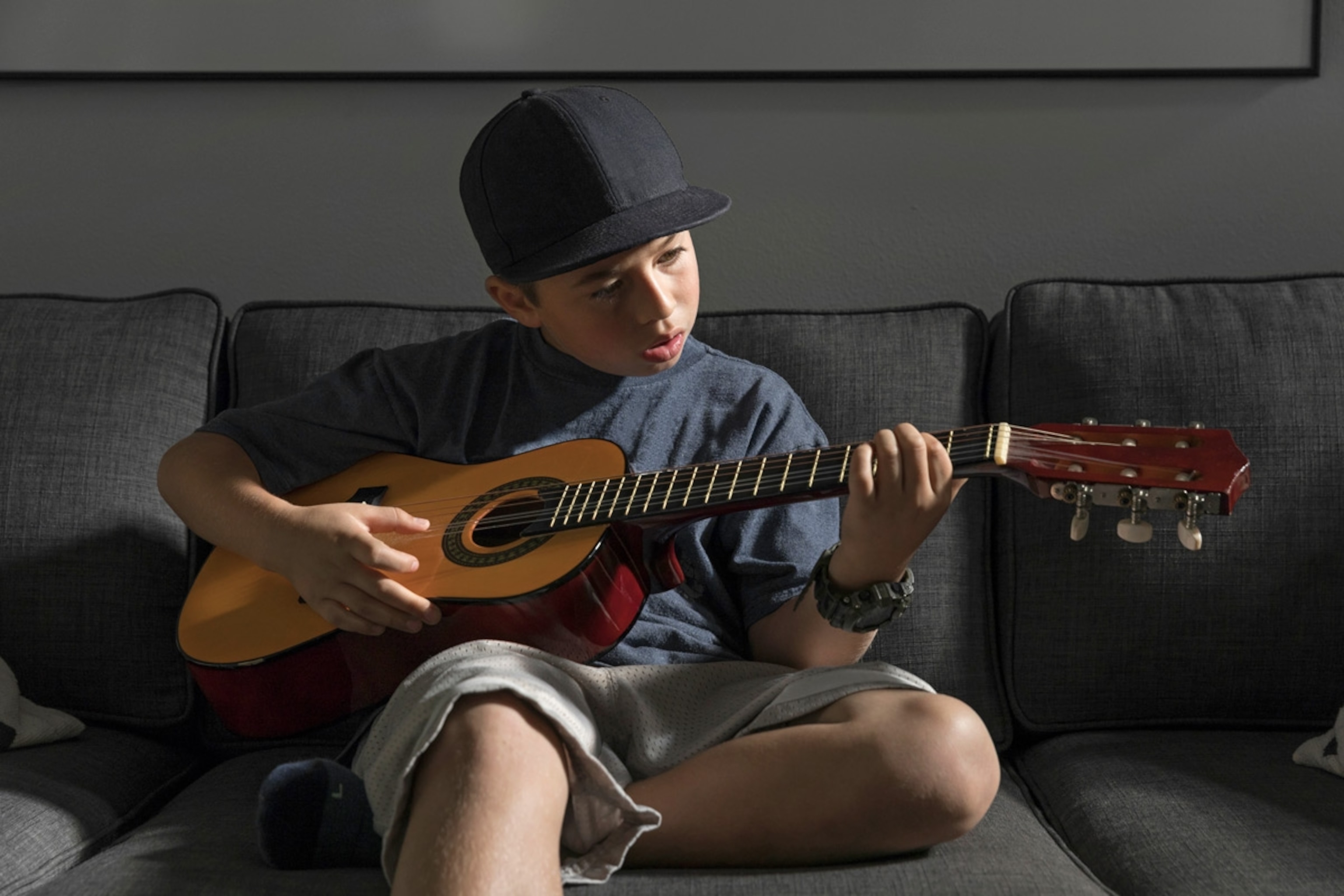 Boy playing guitar, California.