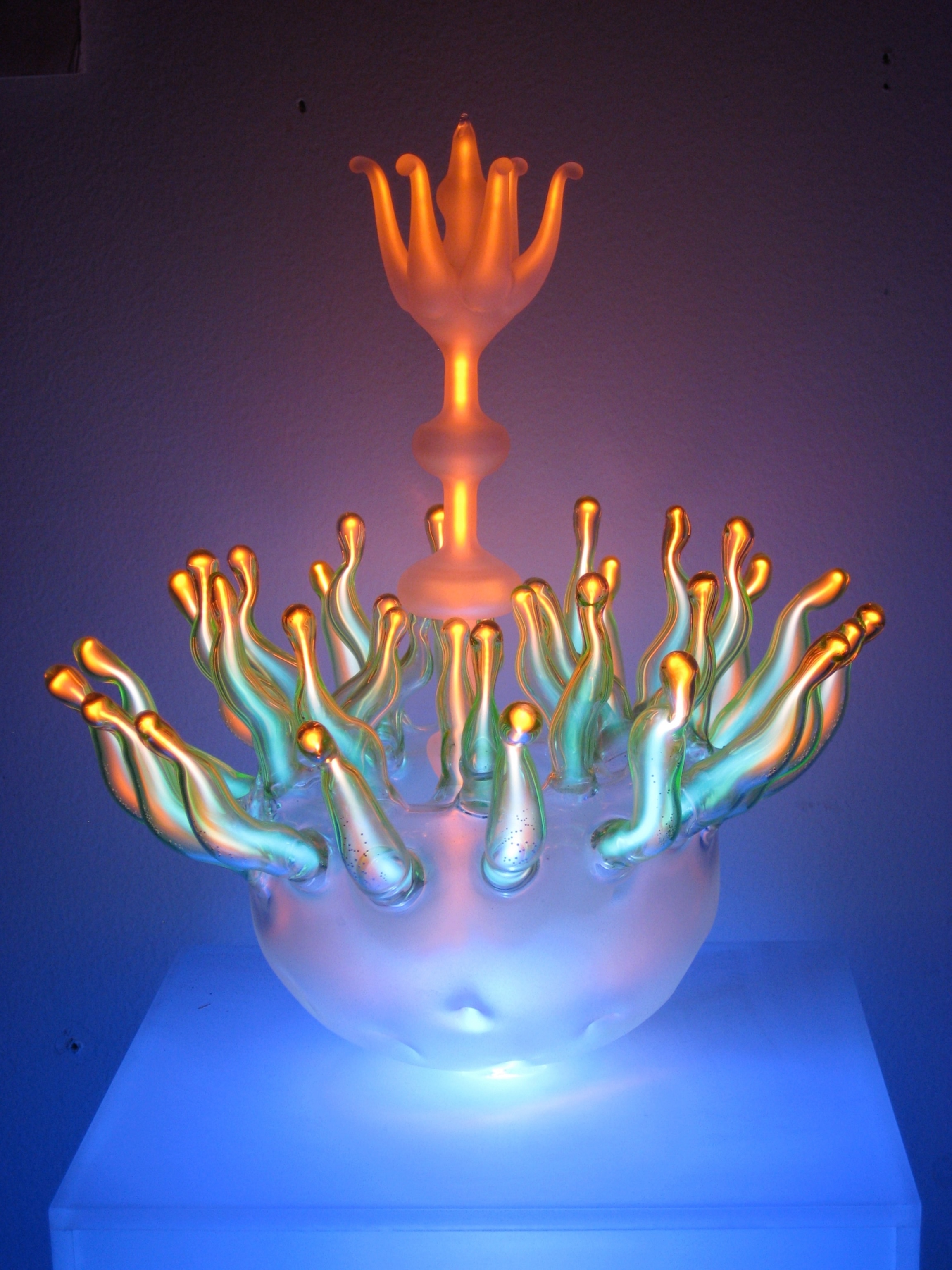A flower scultiure made from neon and glass