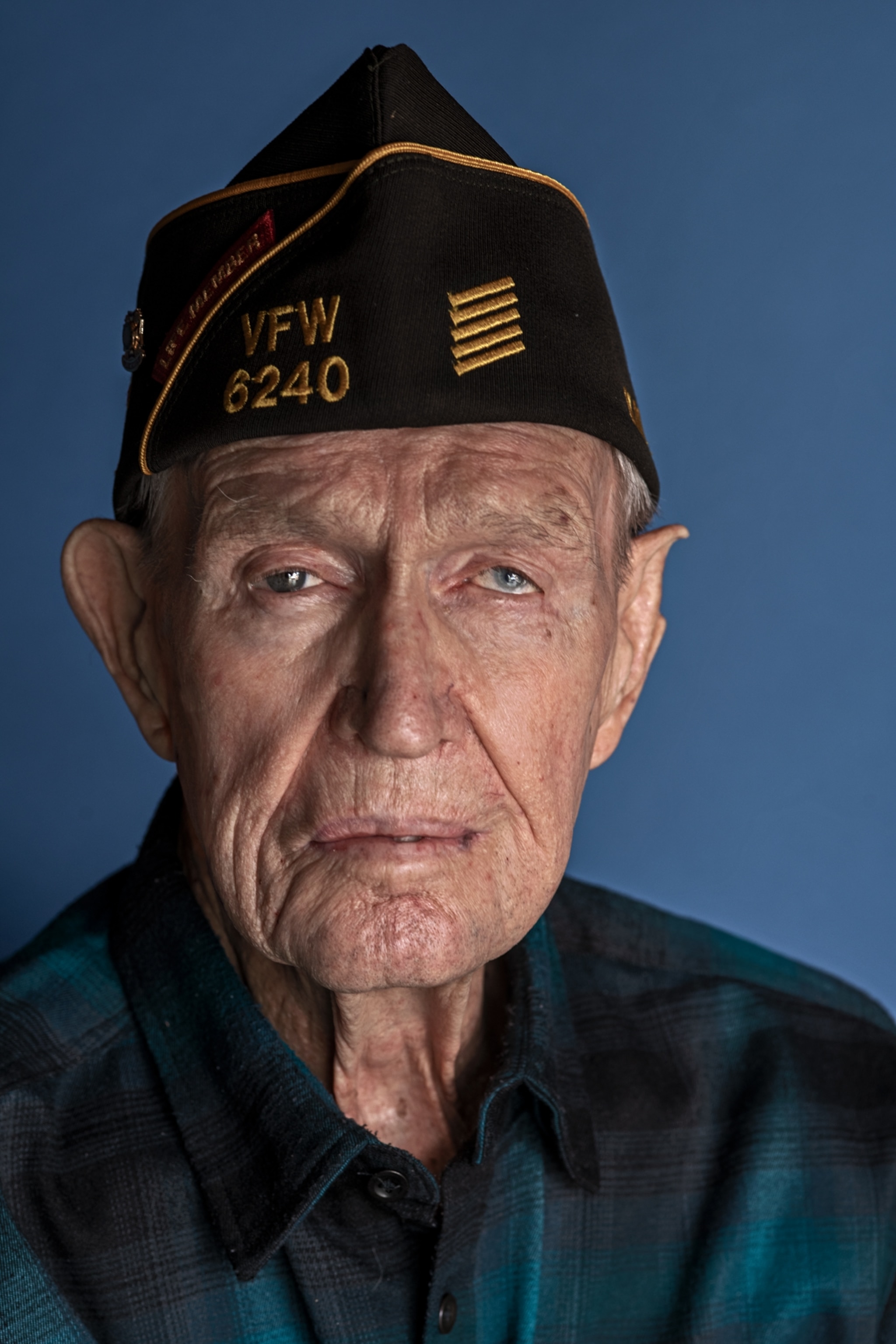 an older man wearing a navy cap