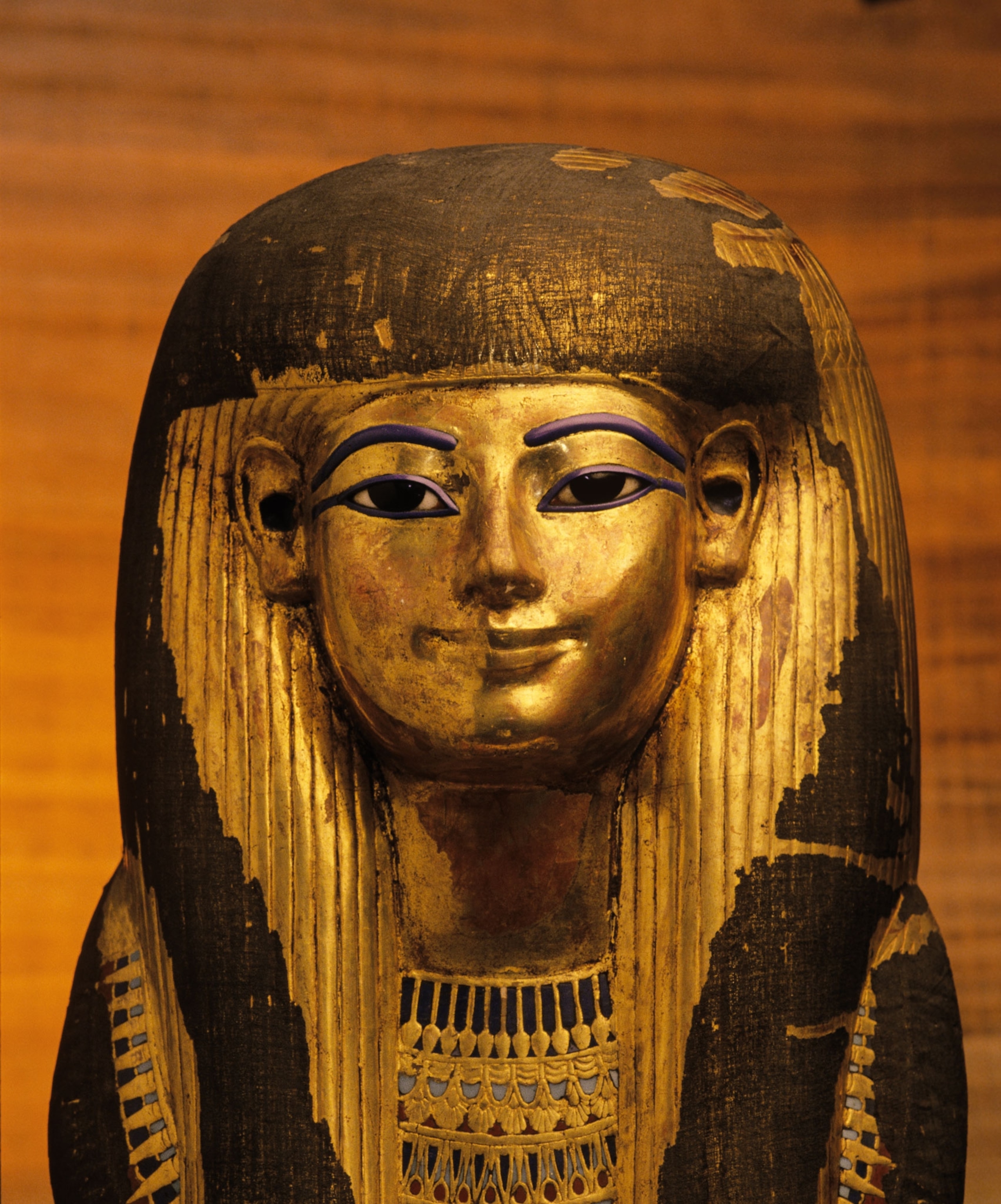 A smiling golden funerary mask