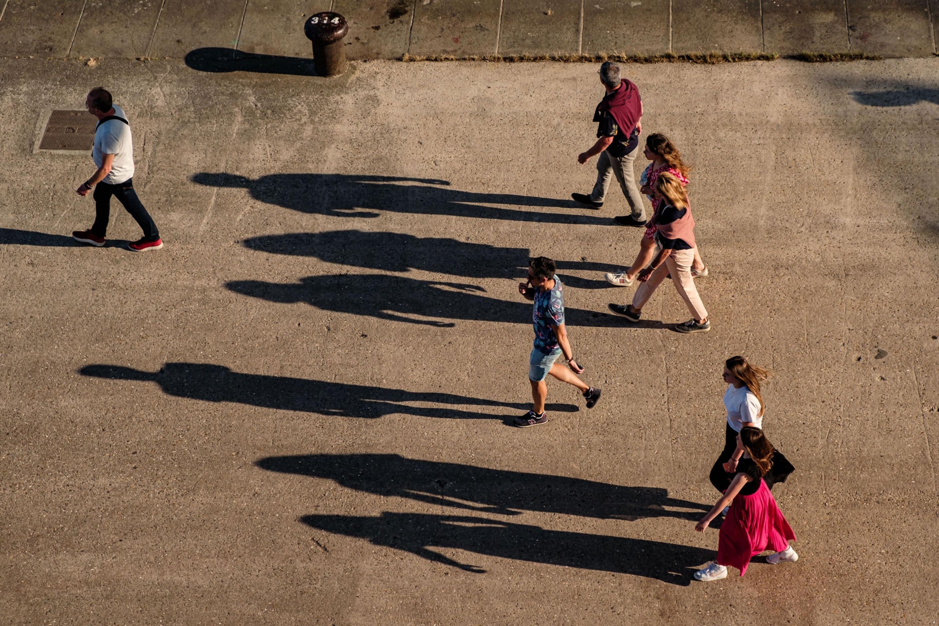 Shadows of pedestrians on the ground