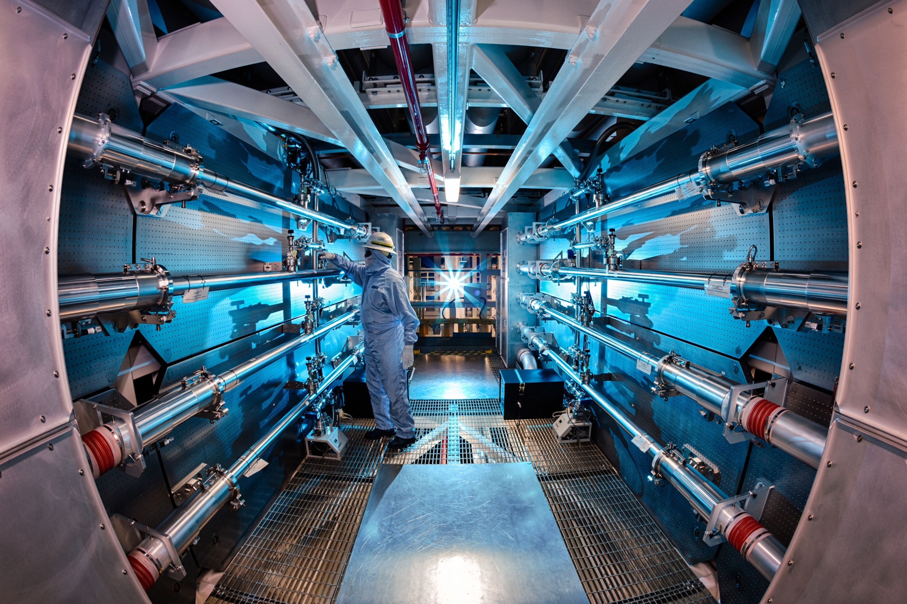 A technician adjusts an optic inside the preamplifier support structure.