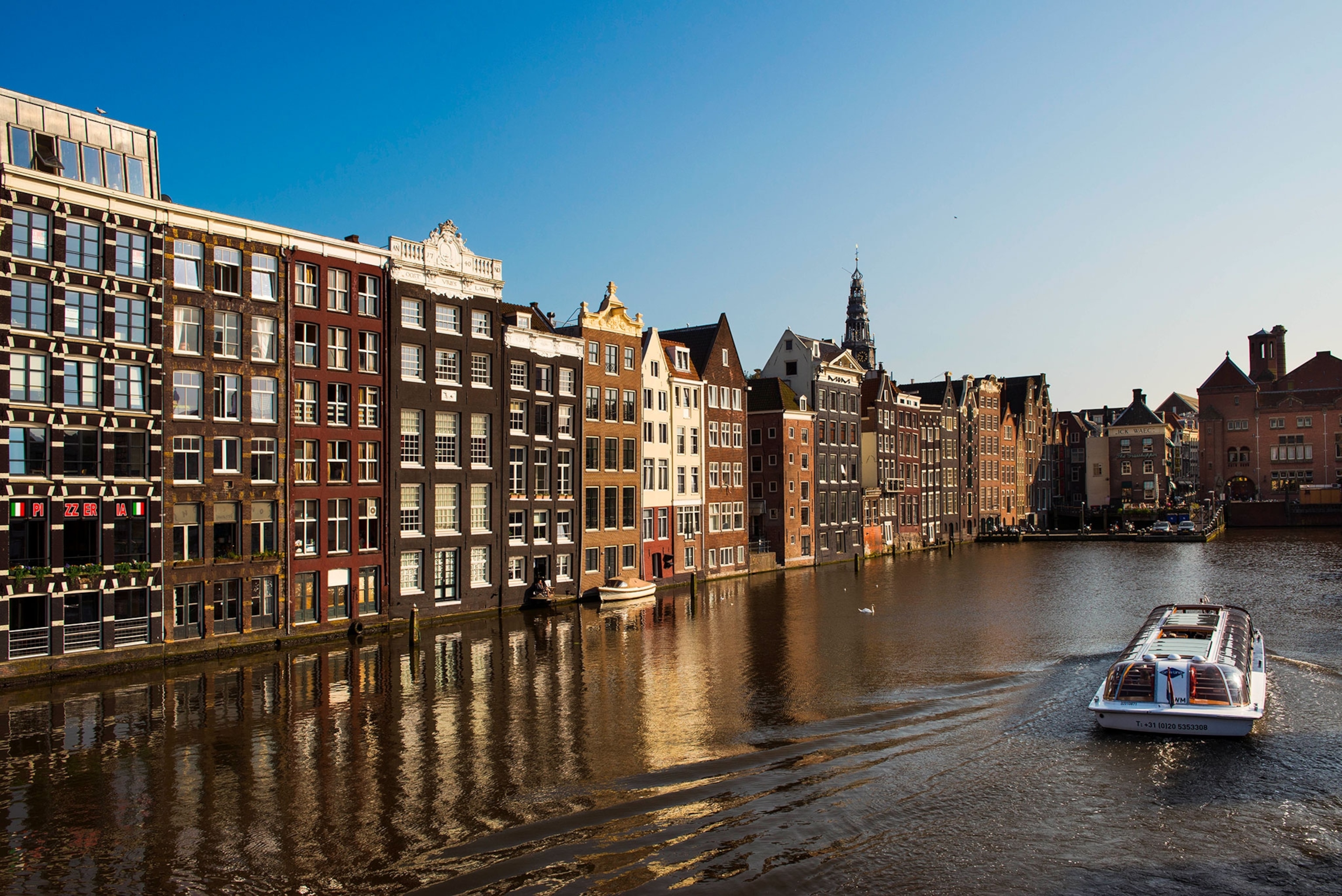 A tourboat along a canal in Amsterdam.