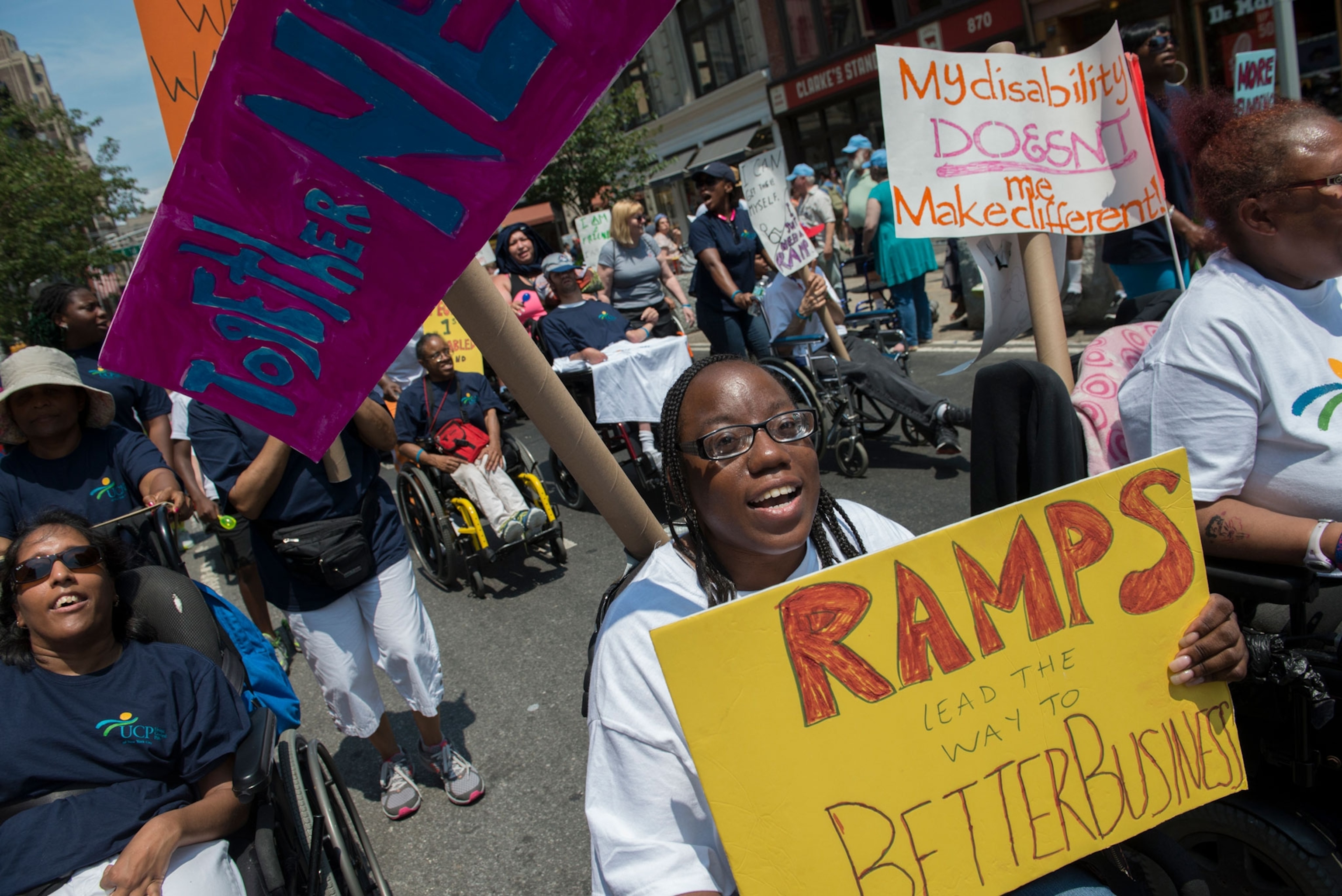 a woman in a wheelchair protesting for ramps