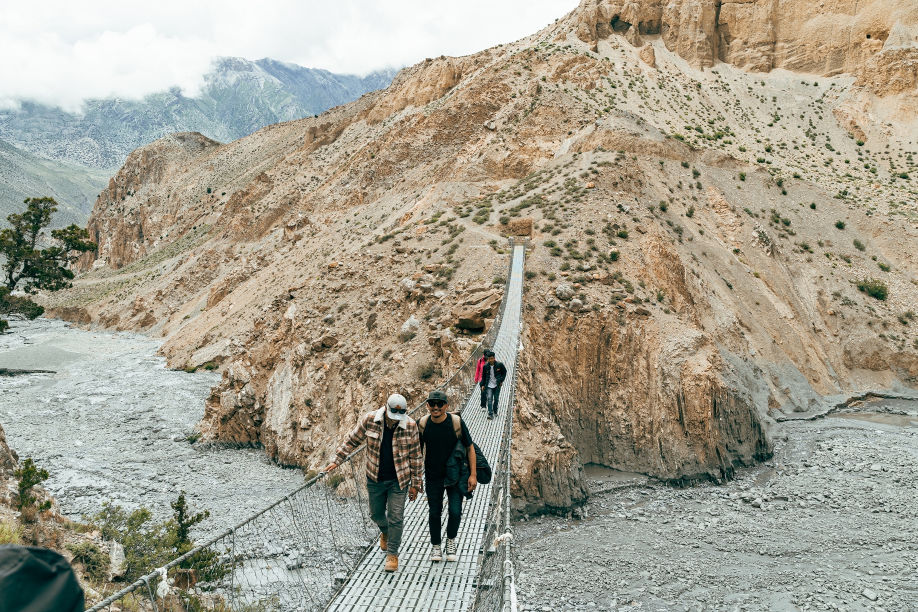 People cross a bridge while on an excursion at the Shinta Mani Mustang.