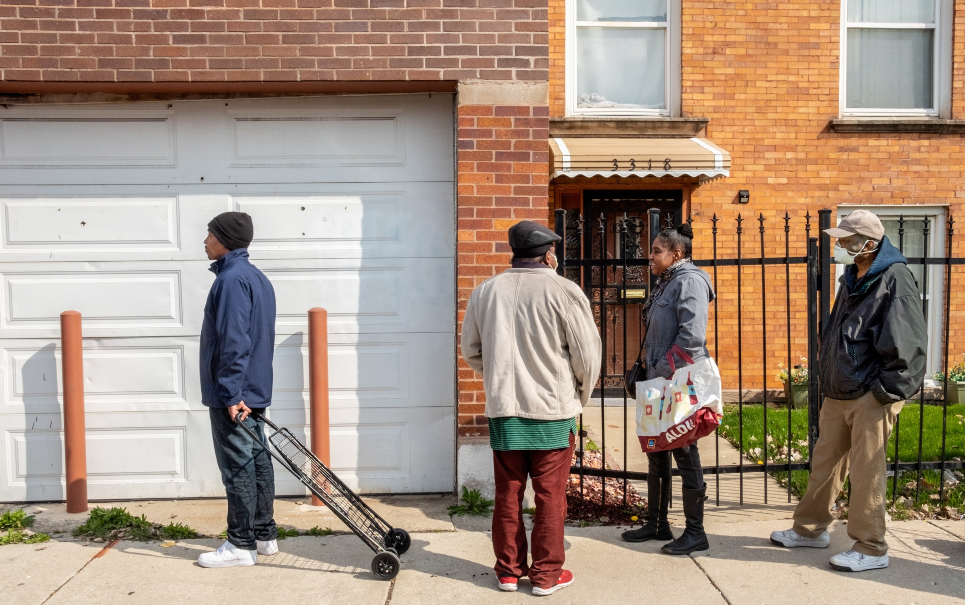 people lined up past a house