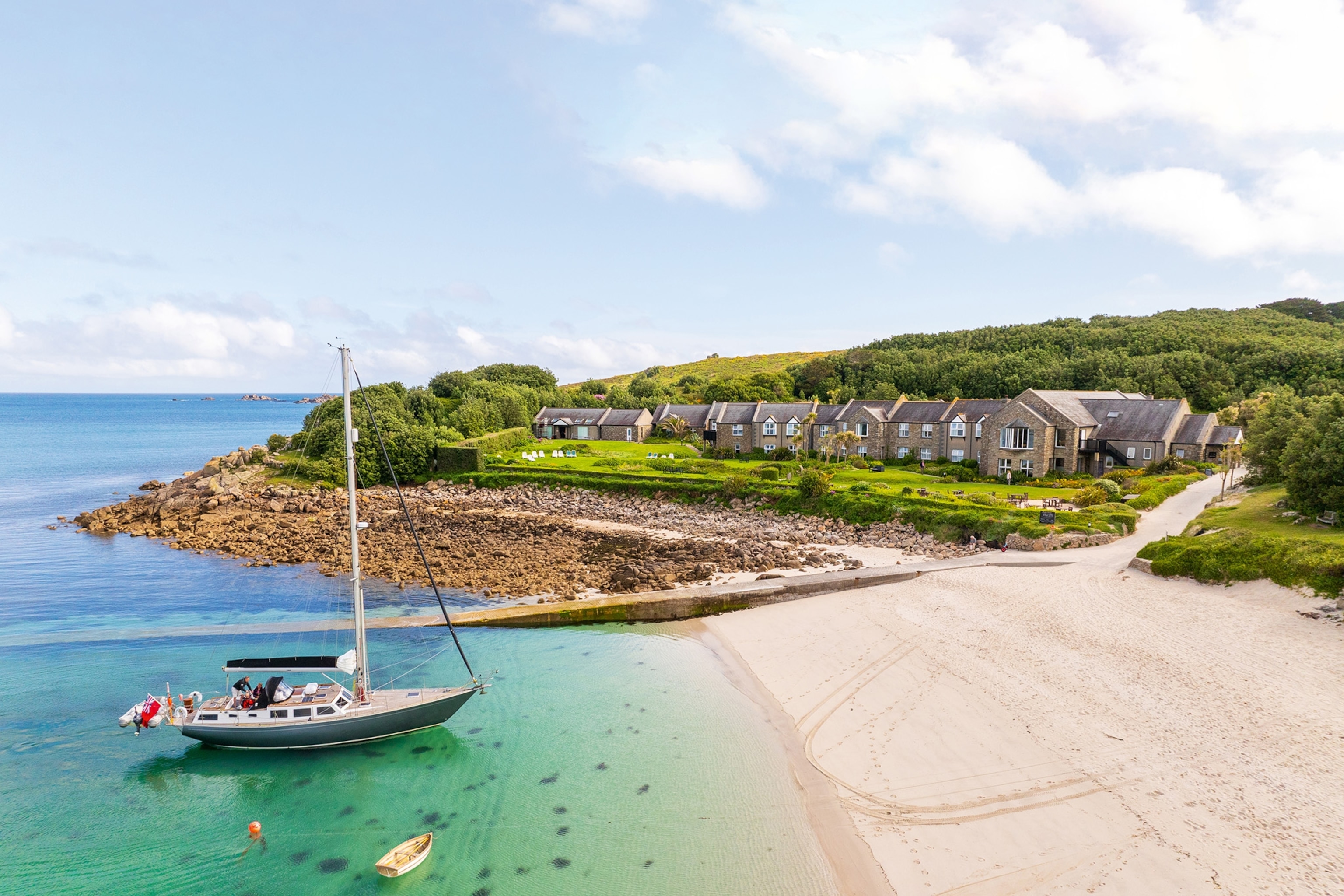 A boat floats near the shore of one of the Isles of Scilly islands in Cornwall.