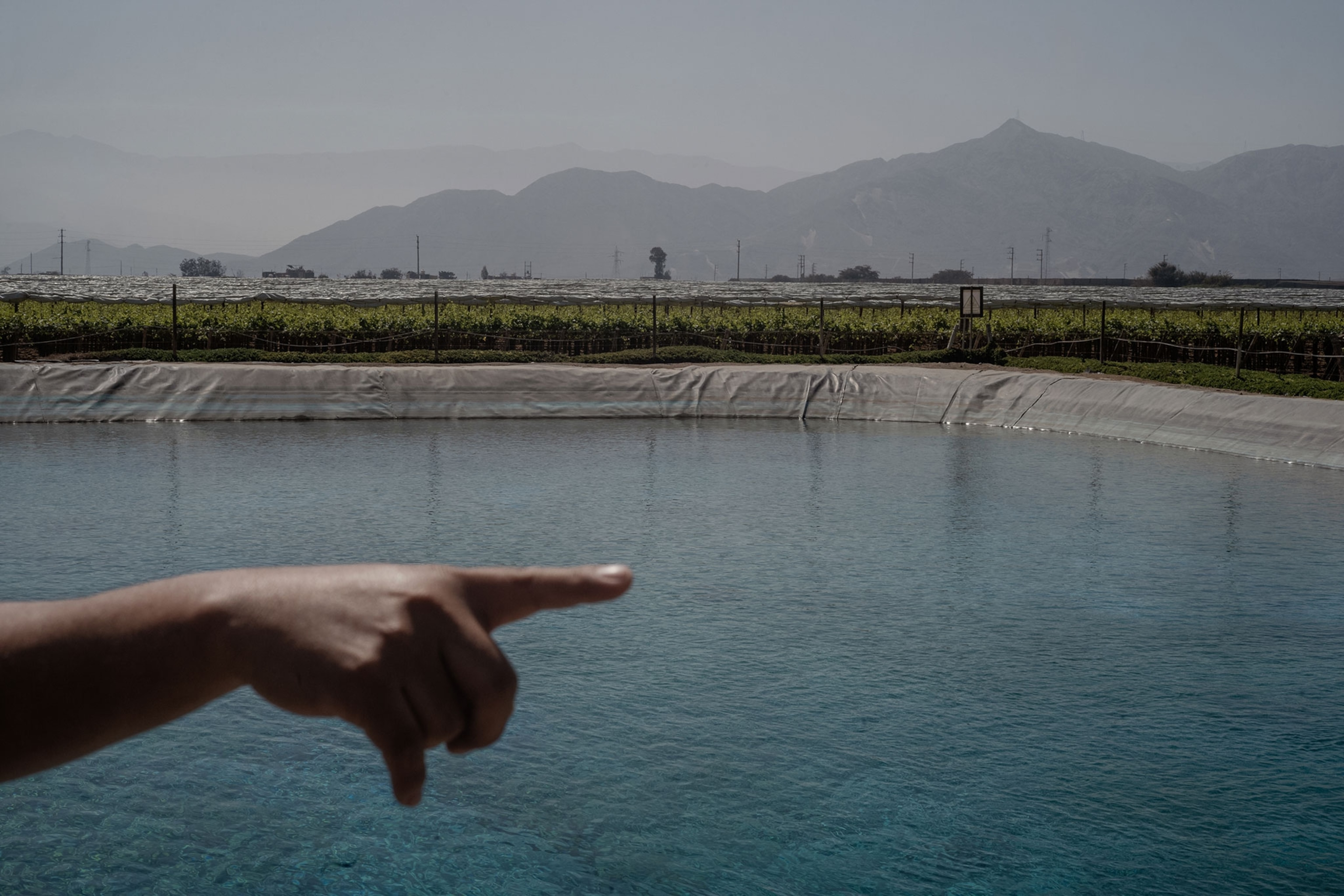 Hand points over a collected body of water.