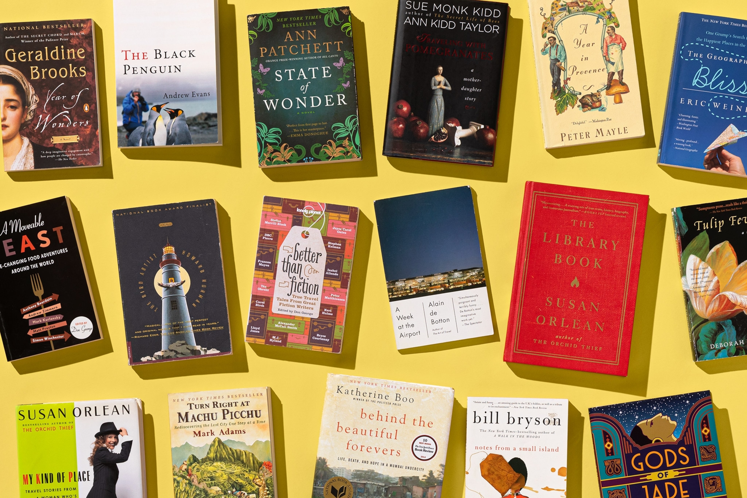 books from the Nat Geo Travel book club on a yellow background in a photo studio