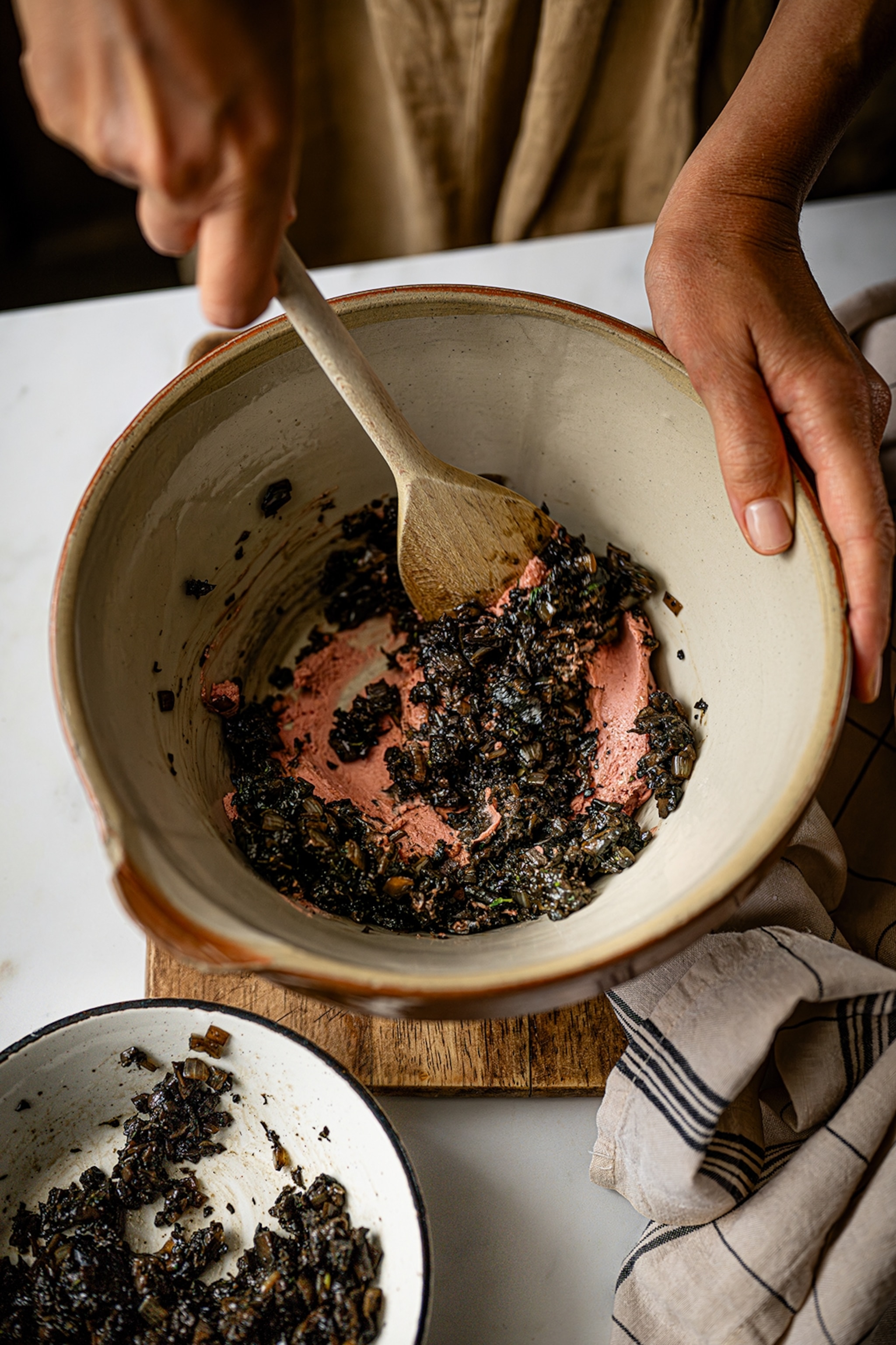 Mixing bowl with pate, mushrooms and a wooden spoon