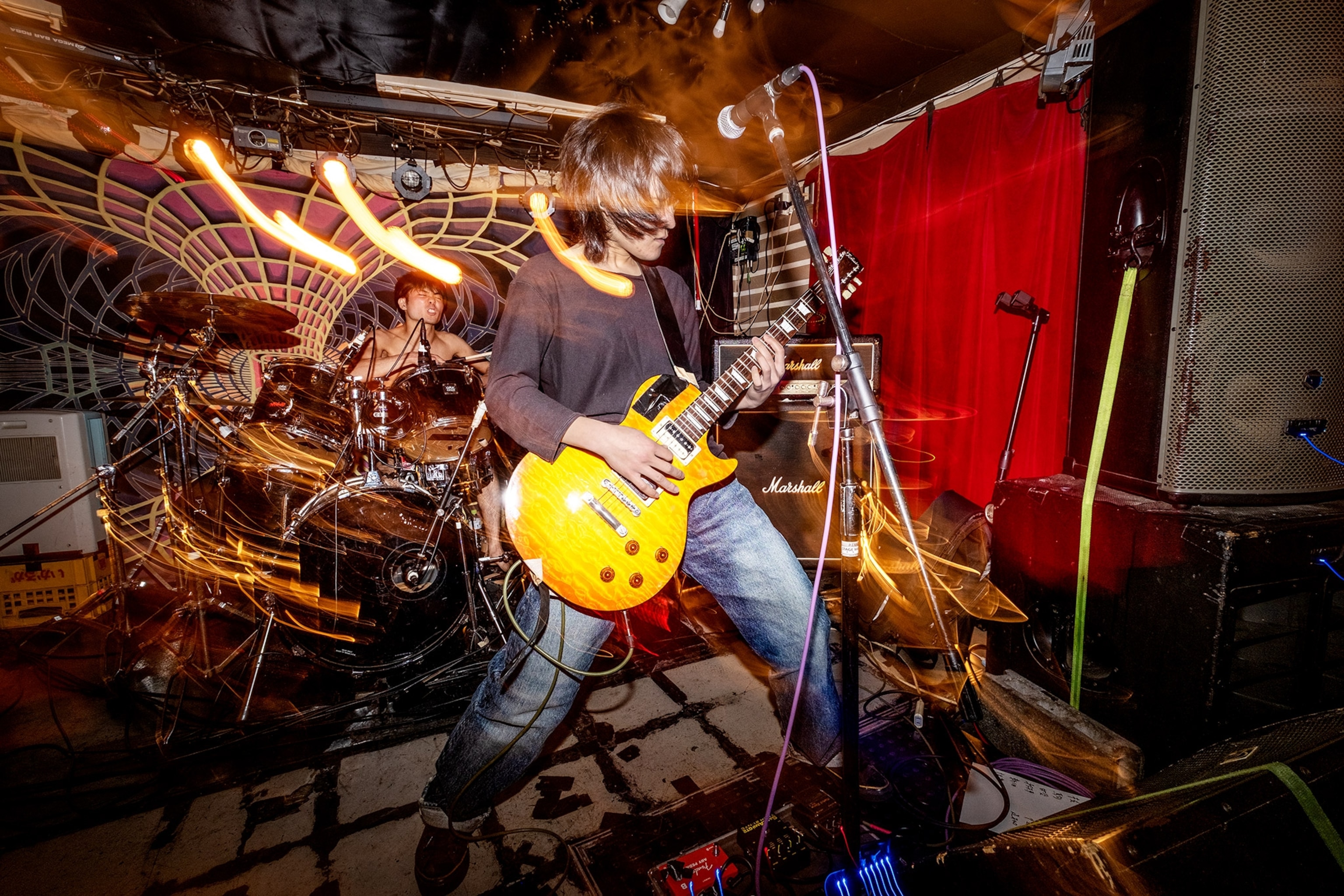 A singer on stage rocks out with a guitar
