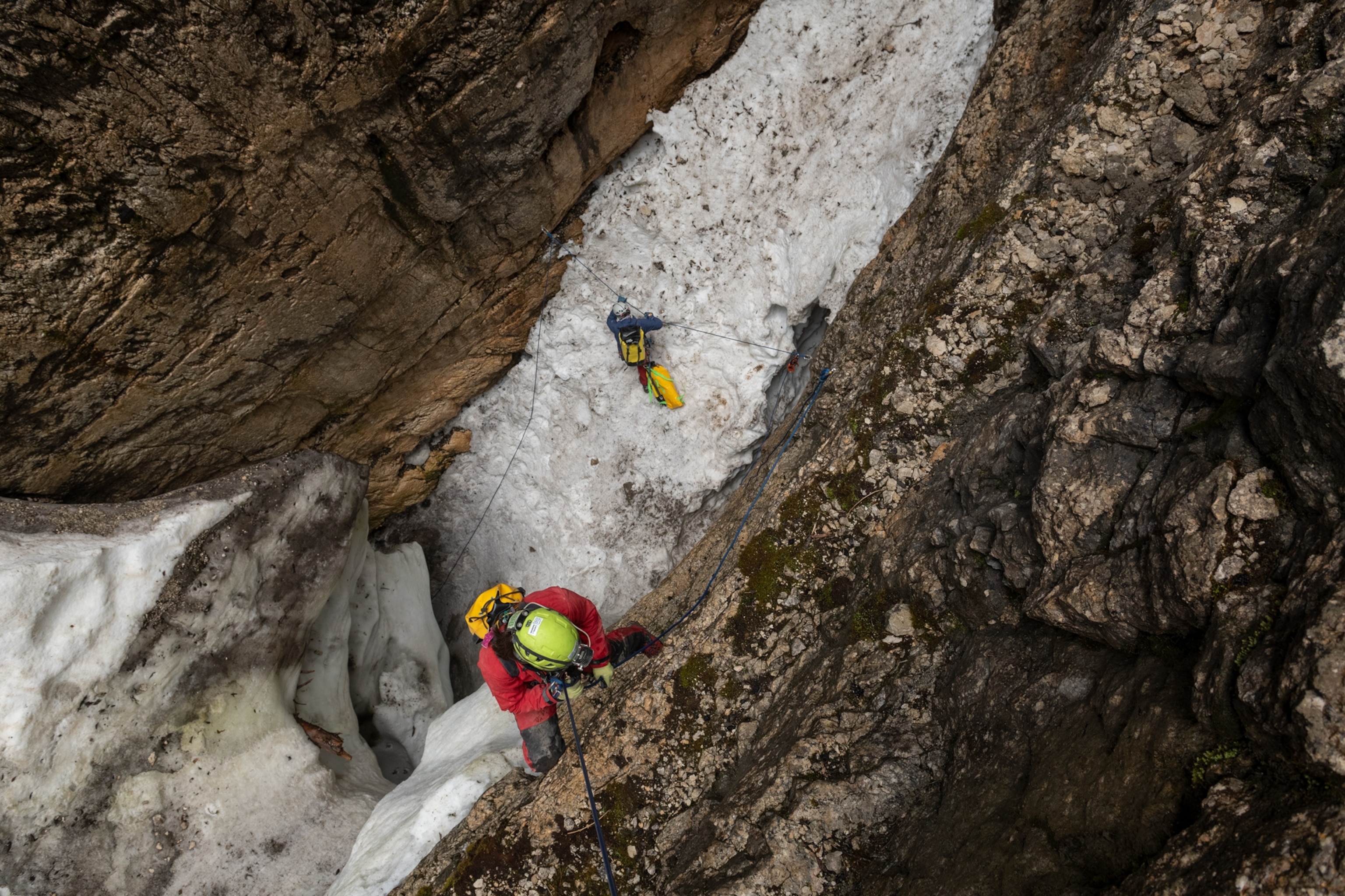 Picture of view from above at two people on vertical wall.