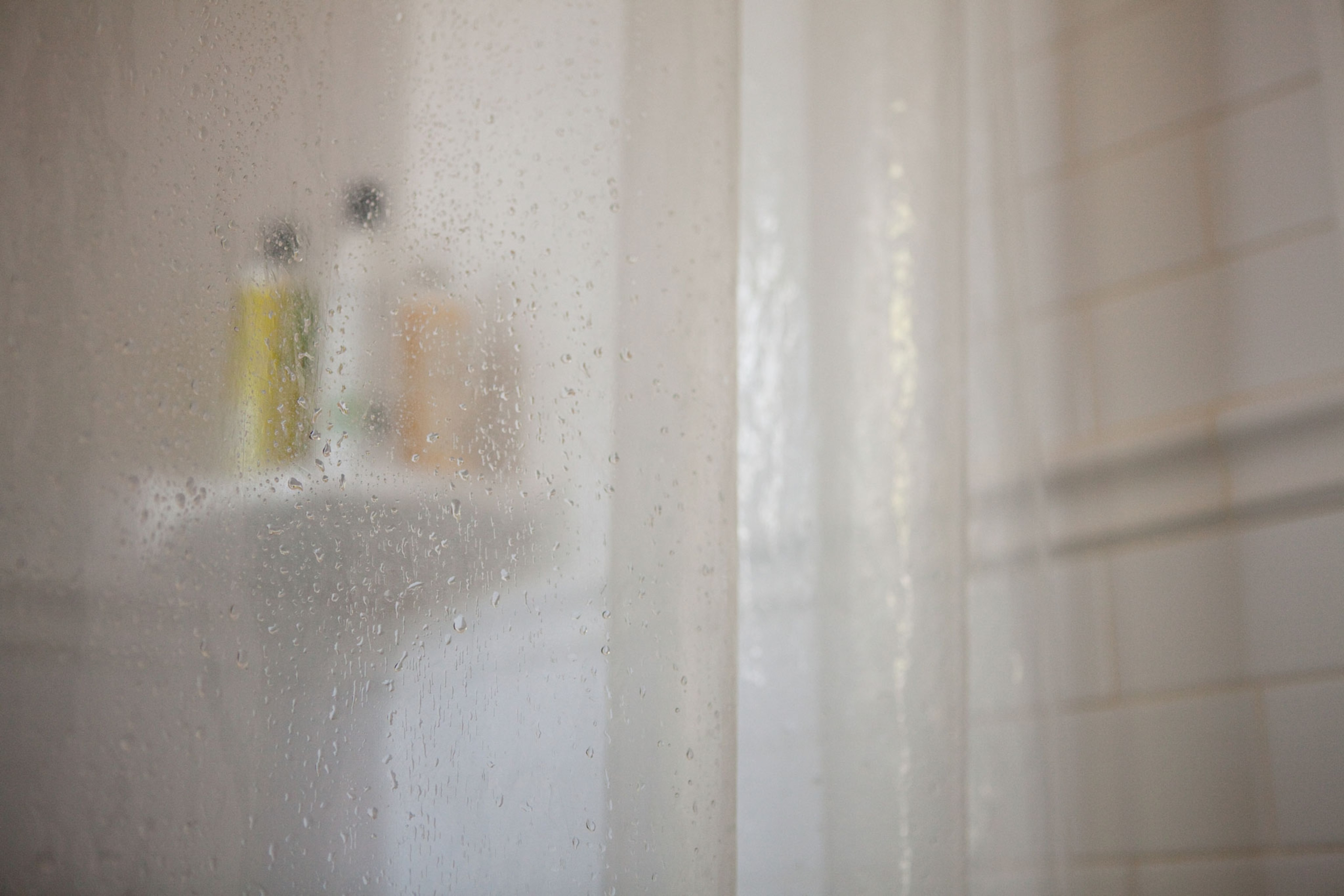 Shower curtain with shampoo bottles
