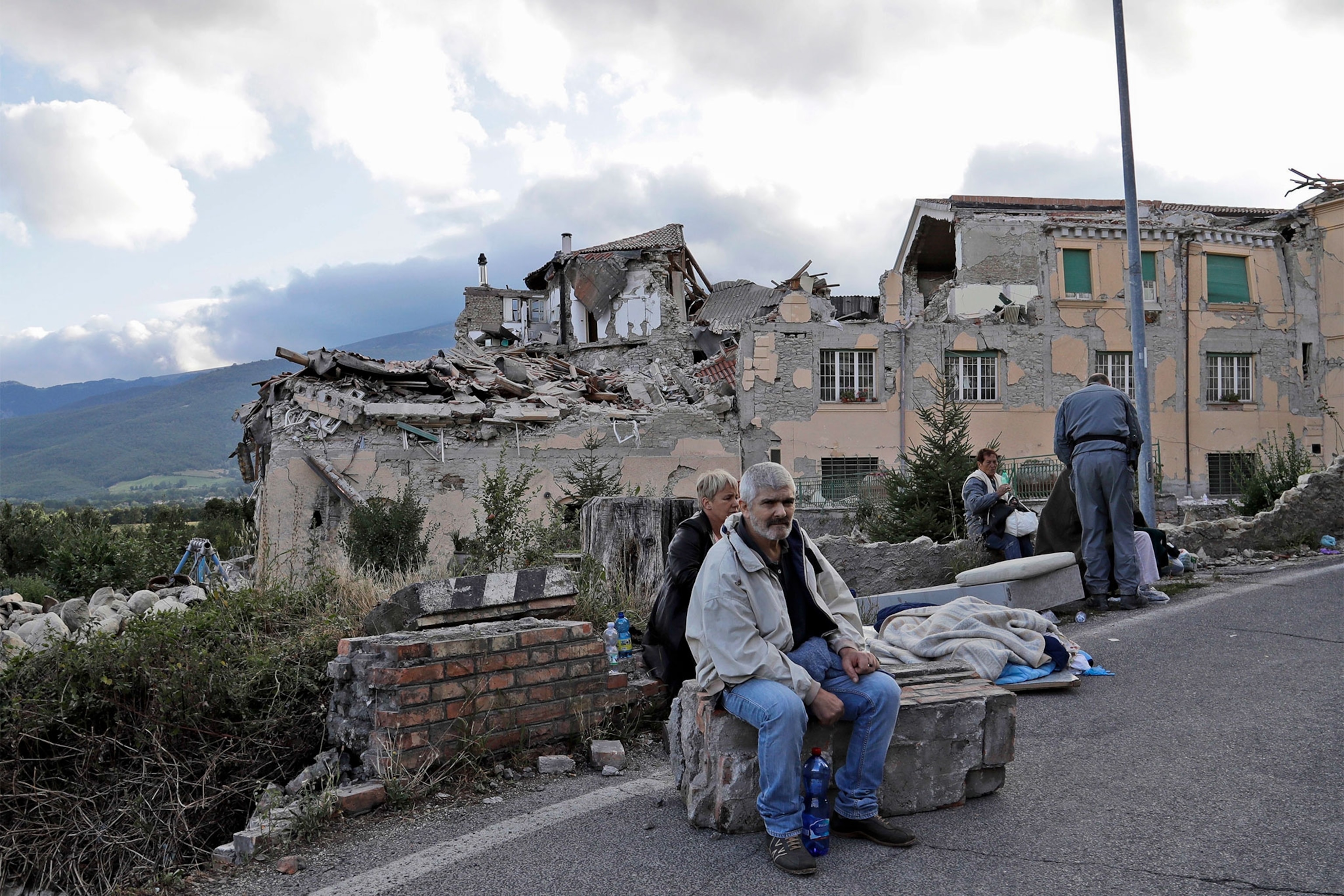 people resting after an earthquake in Italy