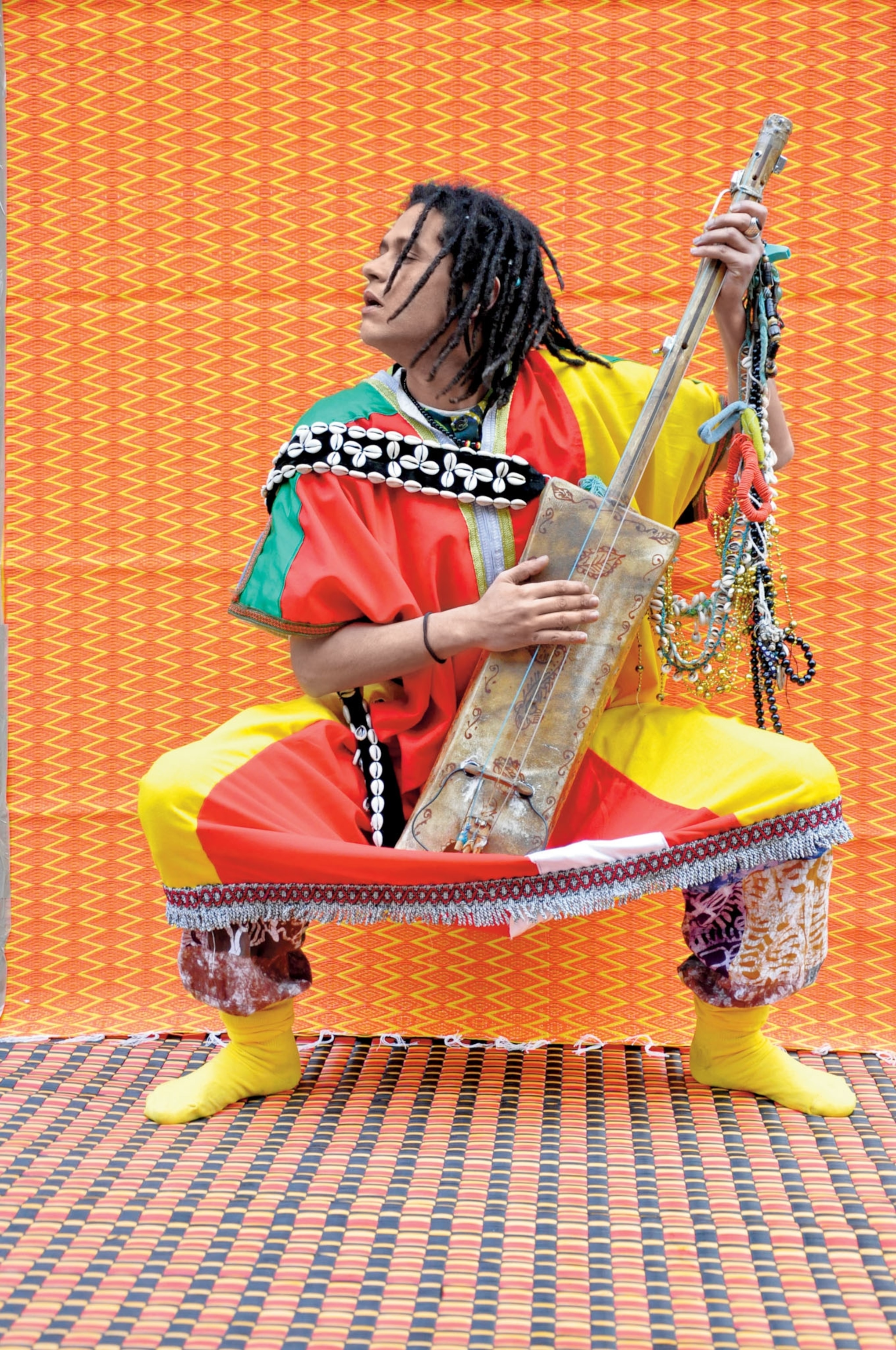 a Moroccan musician playing the uembri in Morocco