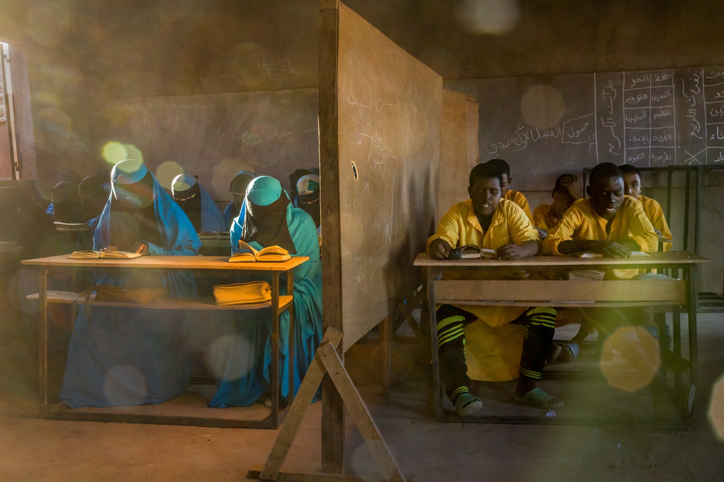 girls and boys in school separated by a wall